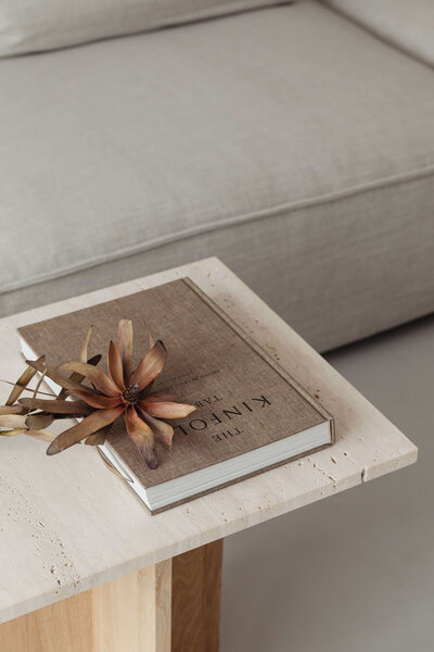 kaboompics_The book lies on a travertine table - Kinfolk - dried flower
