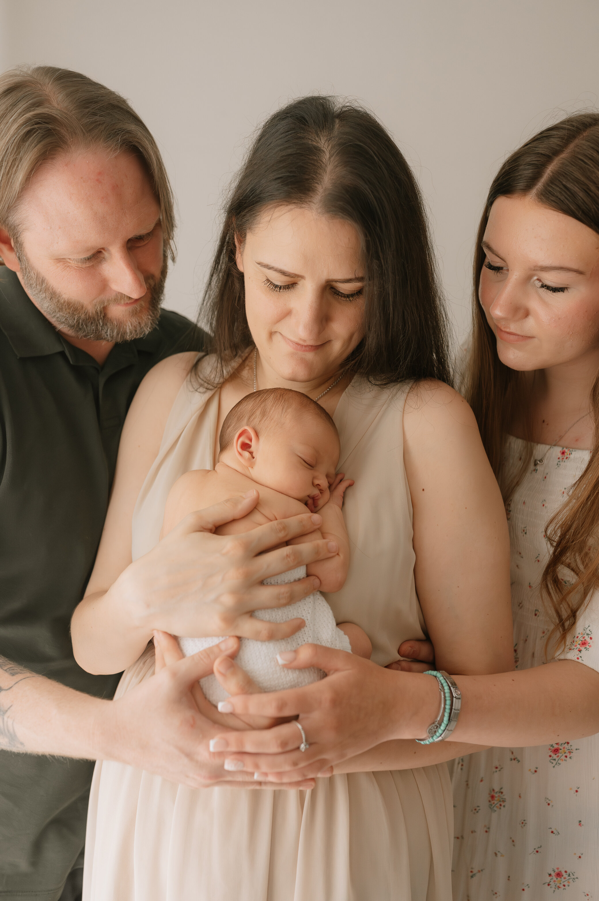 newborn baby girl with her mum, dad and big sister