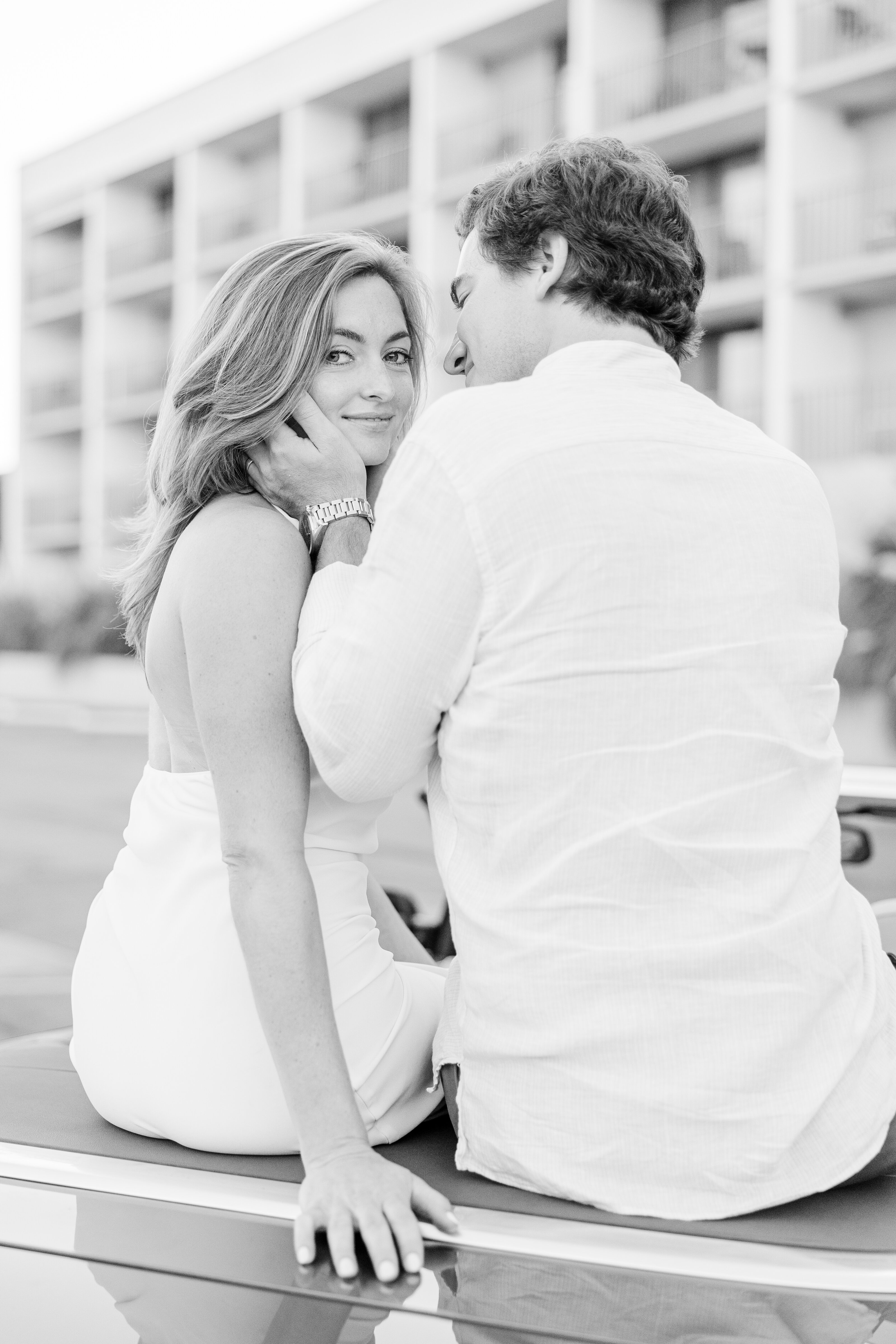 A stylish couple shares an intimate moment during their engagement session in Savannah, GA. A timeless black-and-white editorial portrait capturing romance and elegance.