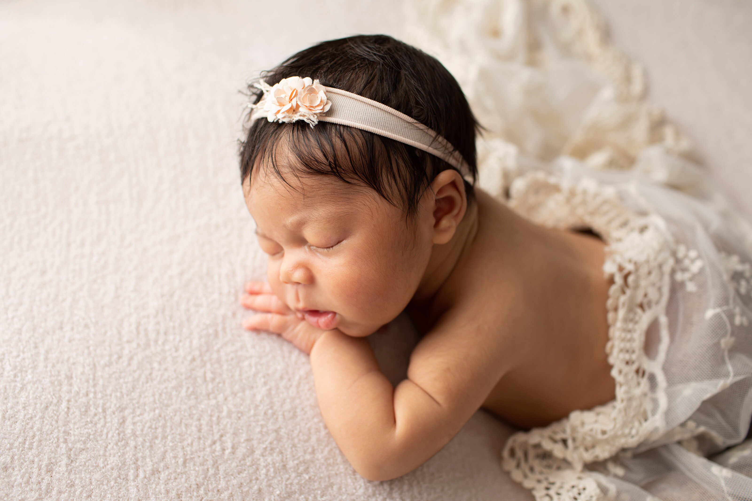 newborn girl in lace wrap and headband