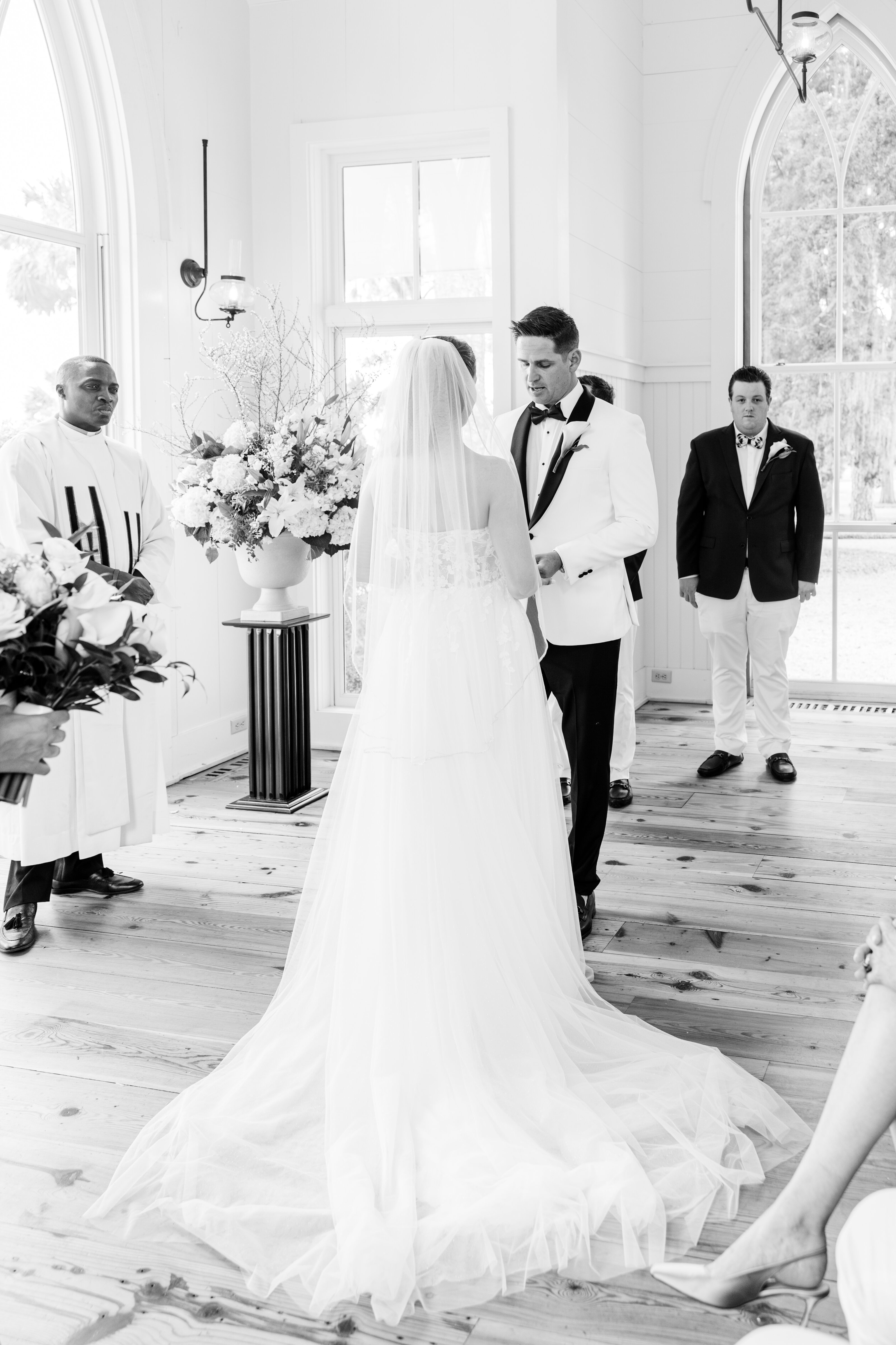 A breathtaking black-and-white capture of a romantic wedding ceremony at Palmetto Bluff. The elegant chapel setting, natural light, and sophisticated details create the perfect ambiance for a luxurious wedding. Amia Marcell Photography specializes in capturing timeless, editorial-style weddings in Palmetto Bluff, offering a refined and artistic approach for couples seeking an elegant and memorable wedding experience.