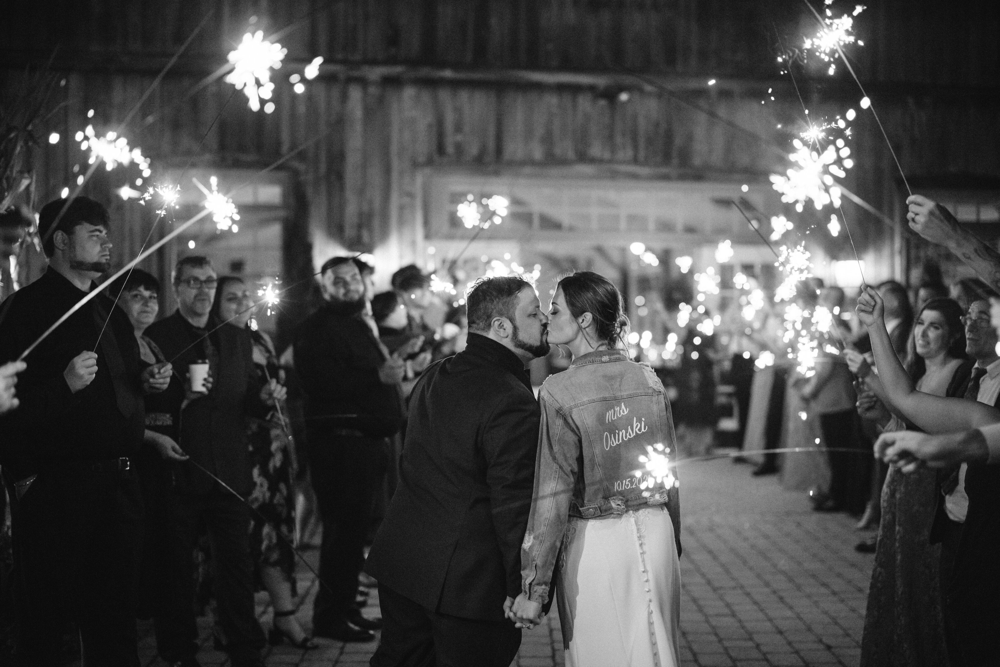 married couple kiss during sparkler exit pictures at New Jersey wedding
