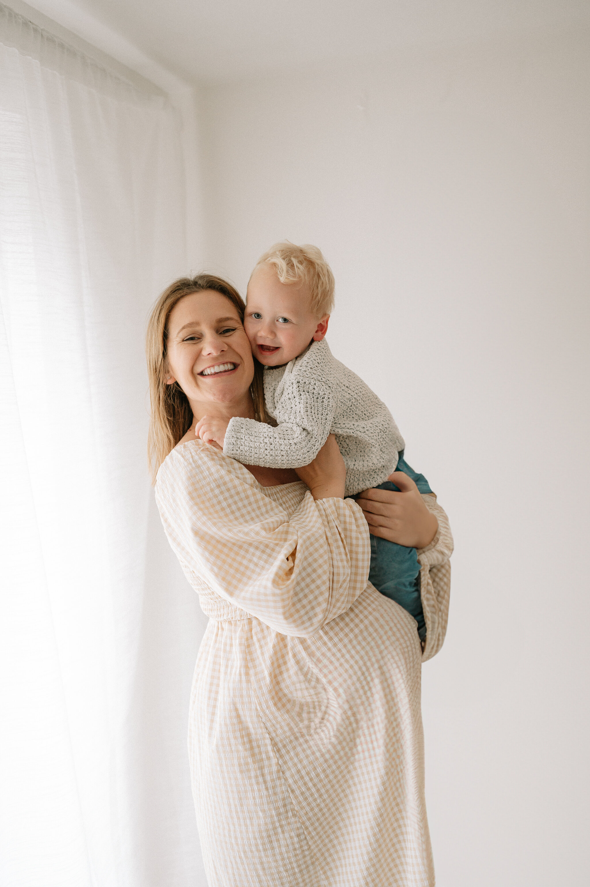2 year old boy on mums pregnant belly