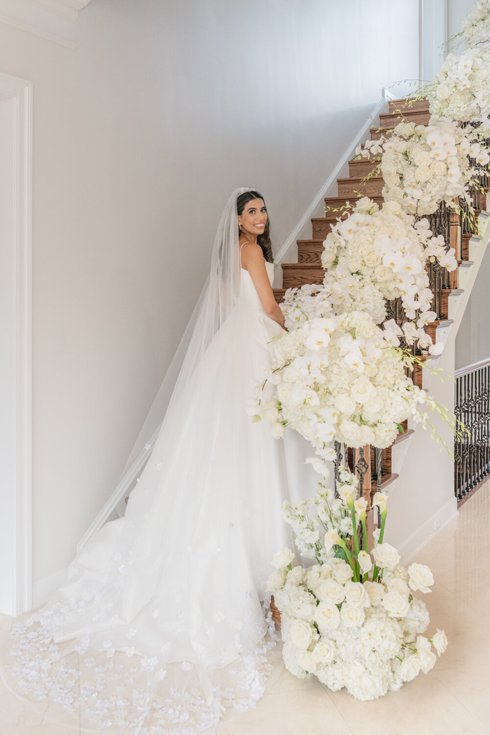 white-orchids-wedding-flowers-bride-on-staircase-karenadixon-2022-120