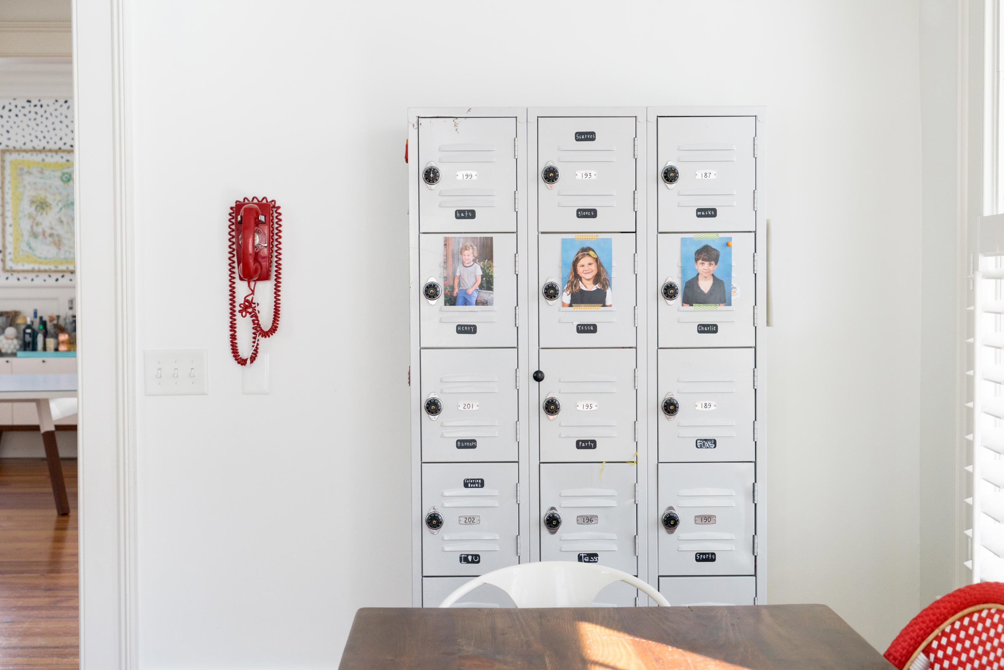 3 rows of lockers and a vintage red phone in a dining room