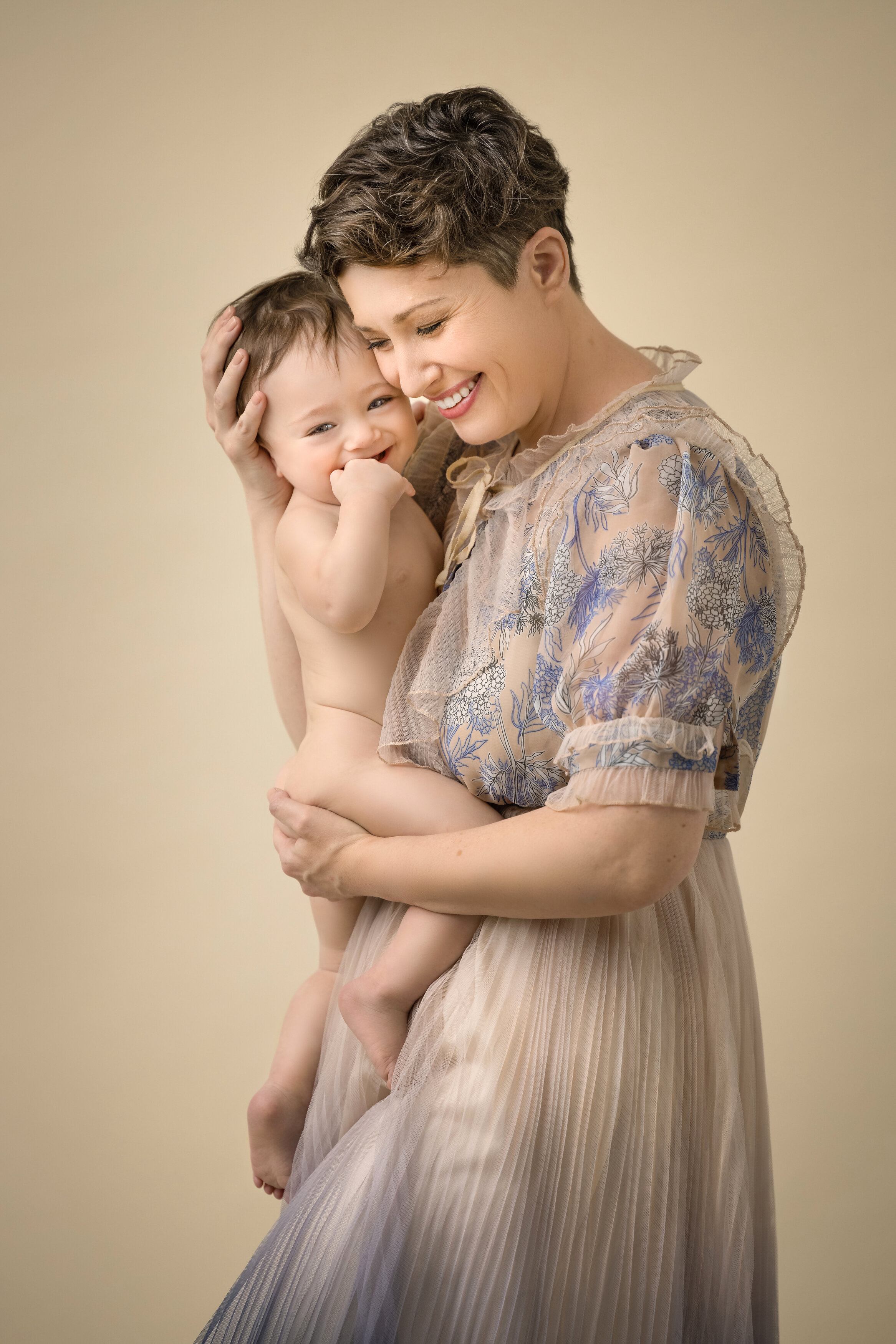 mom holds her child during a family portrait session  in NJ photo studio.