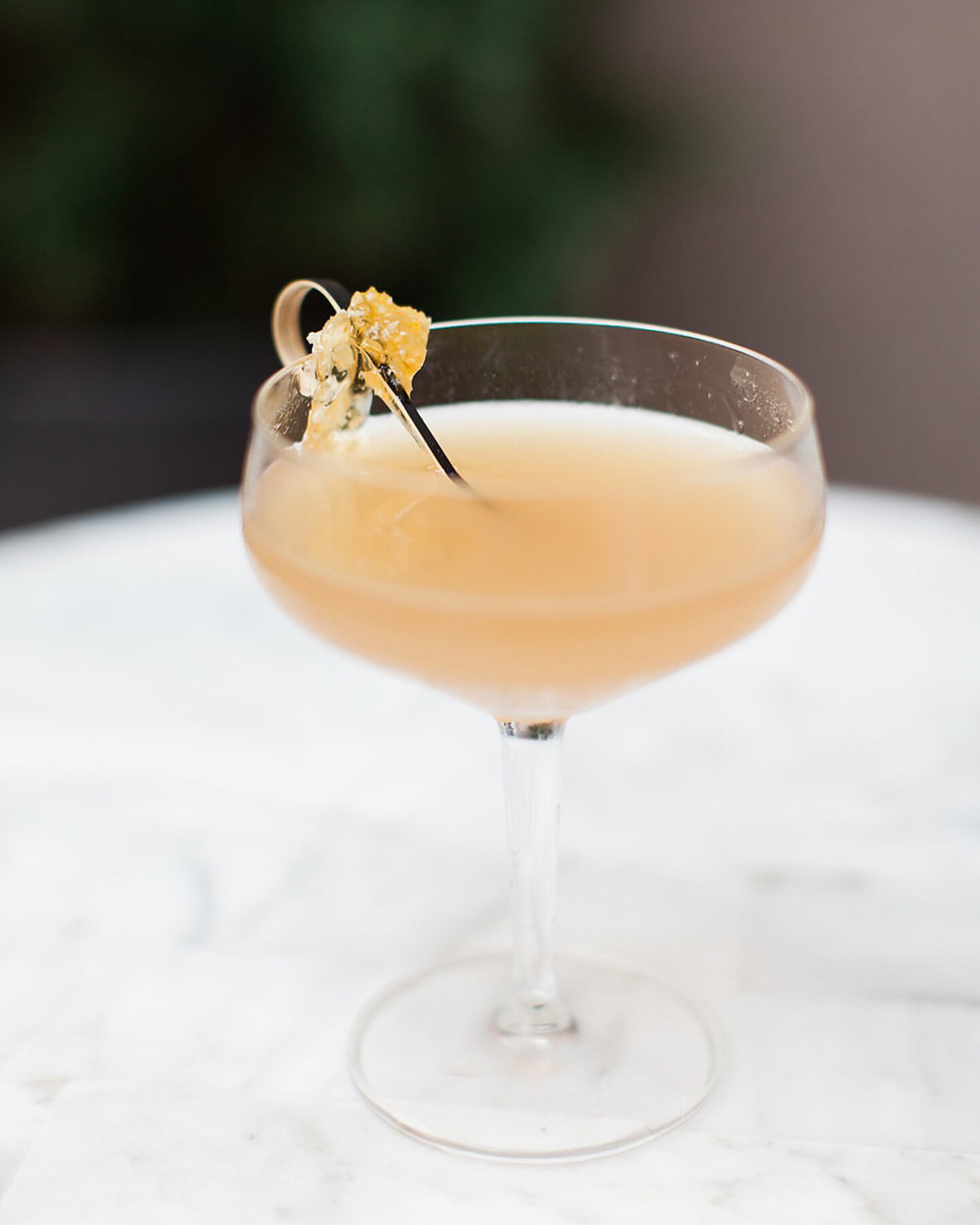 Cute spritz cocktail in peach color with flower garnish