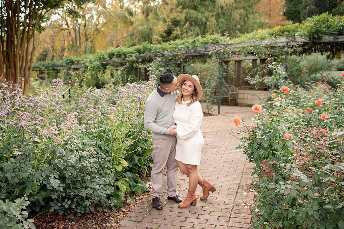 Couple smiling and posing in outdoor garden by Maryland Family Photographer