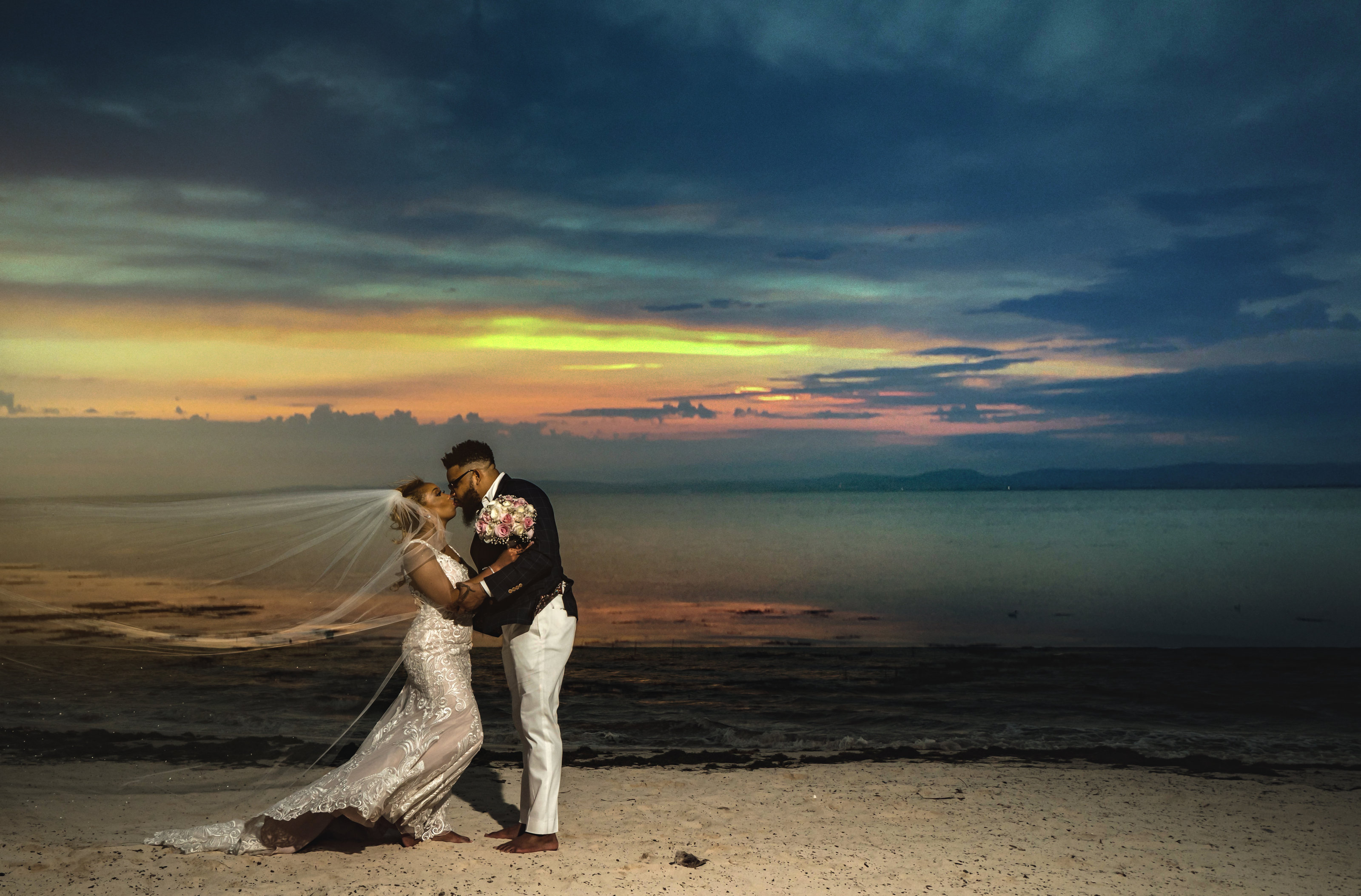 flowy veil in couples portraits on the beach in cancun mexico