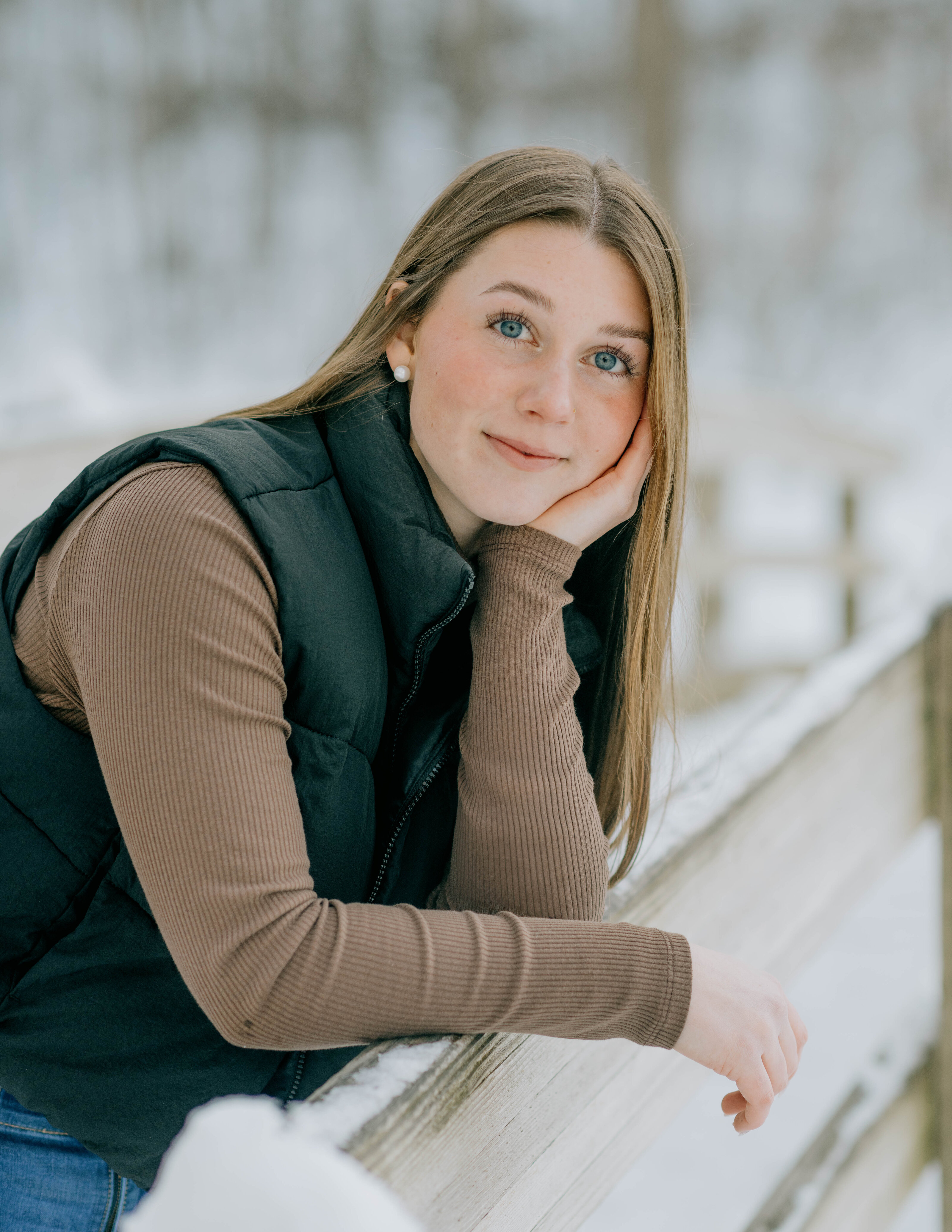 High school senior Sadee leans across the bridge at the Edith J. Carrier Arboretum.