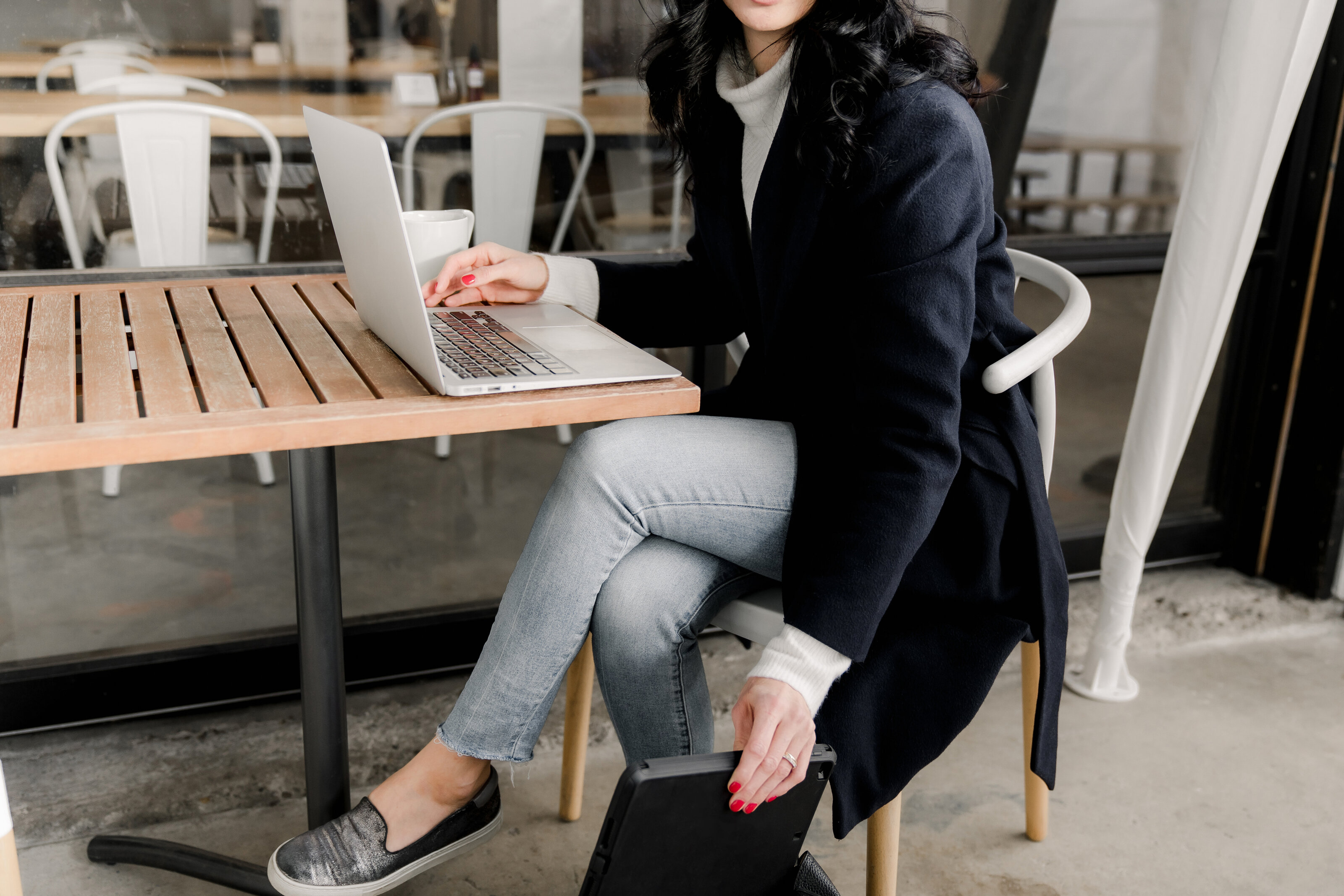 Portrait of Michelle, founder of The Systems Café, sitting confidently in a professional yet relaxed setting, symbolizing her approachable and organized approach to helping entrepreneurs streamline their workflows and achieve business success