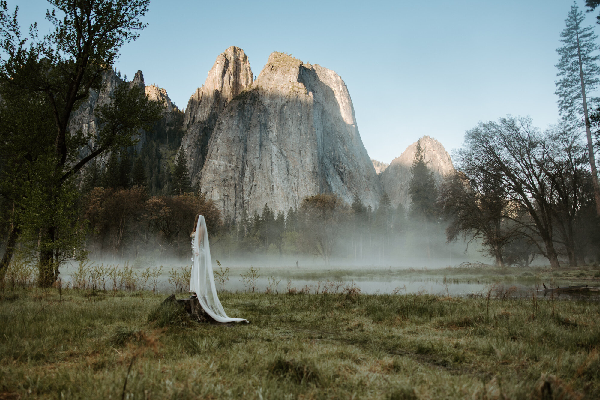 Yosemite bride overlooking valley at sunrise after elopement