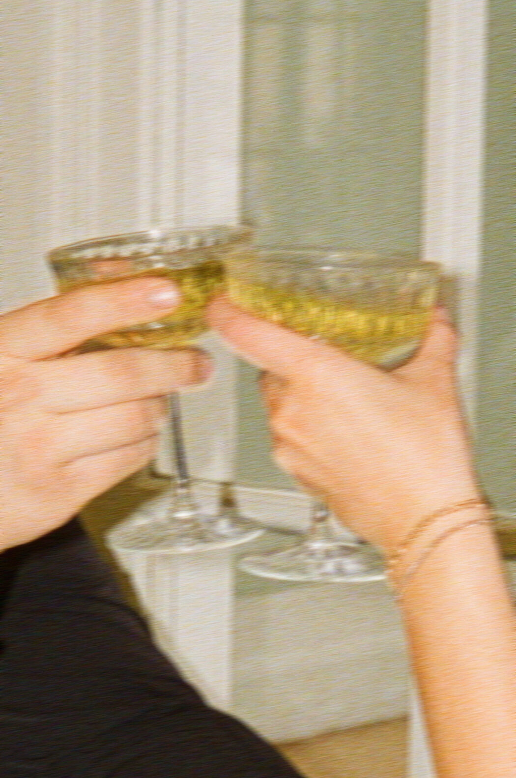 a couple cheersing two champagne coupes