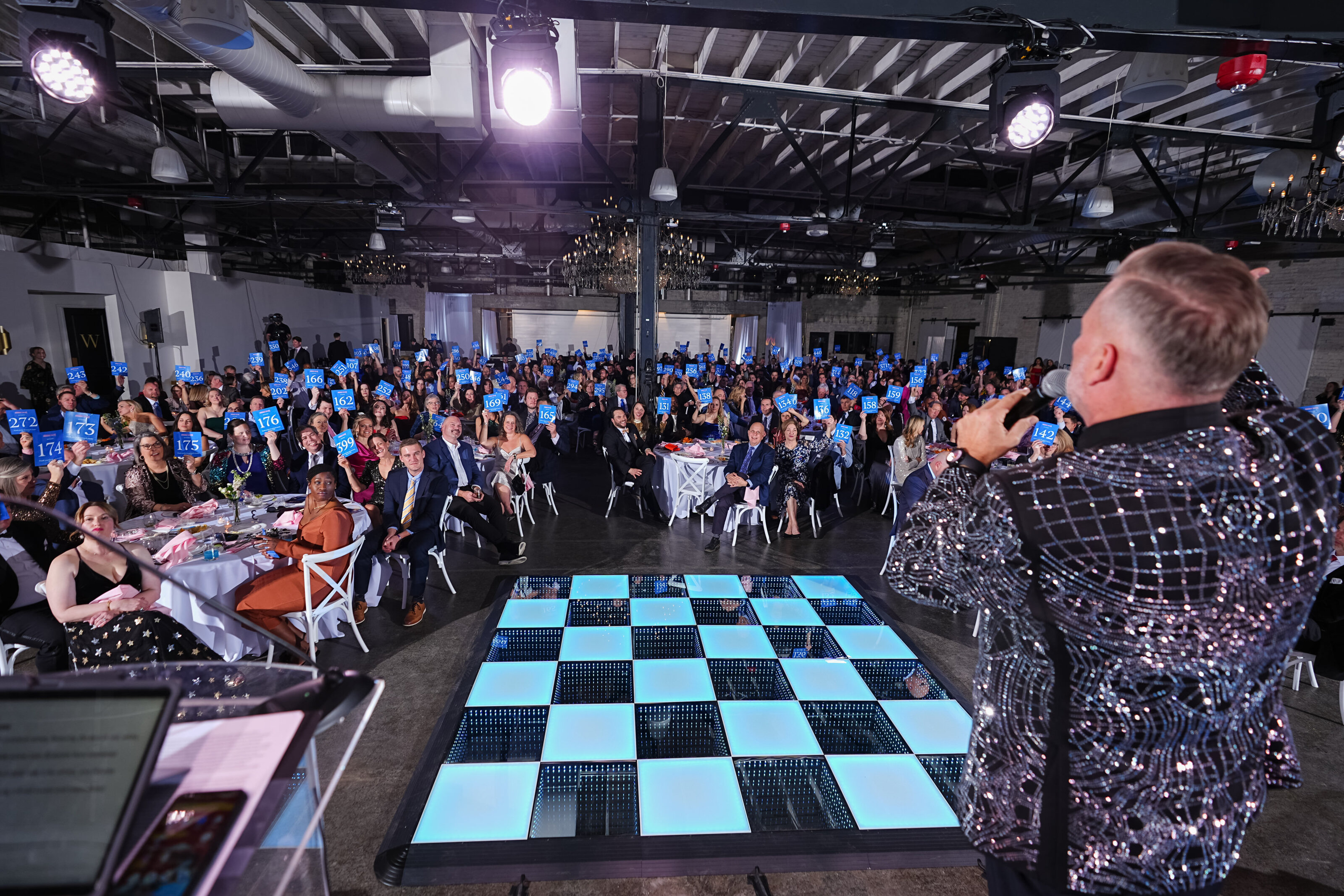 kansas-city-event-photography-0074-event-host-on-stage-with-chessboard-display