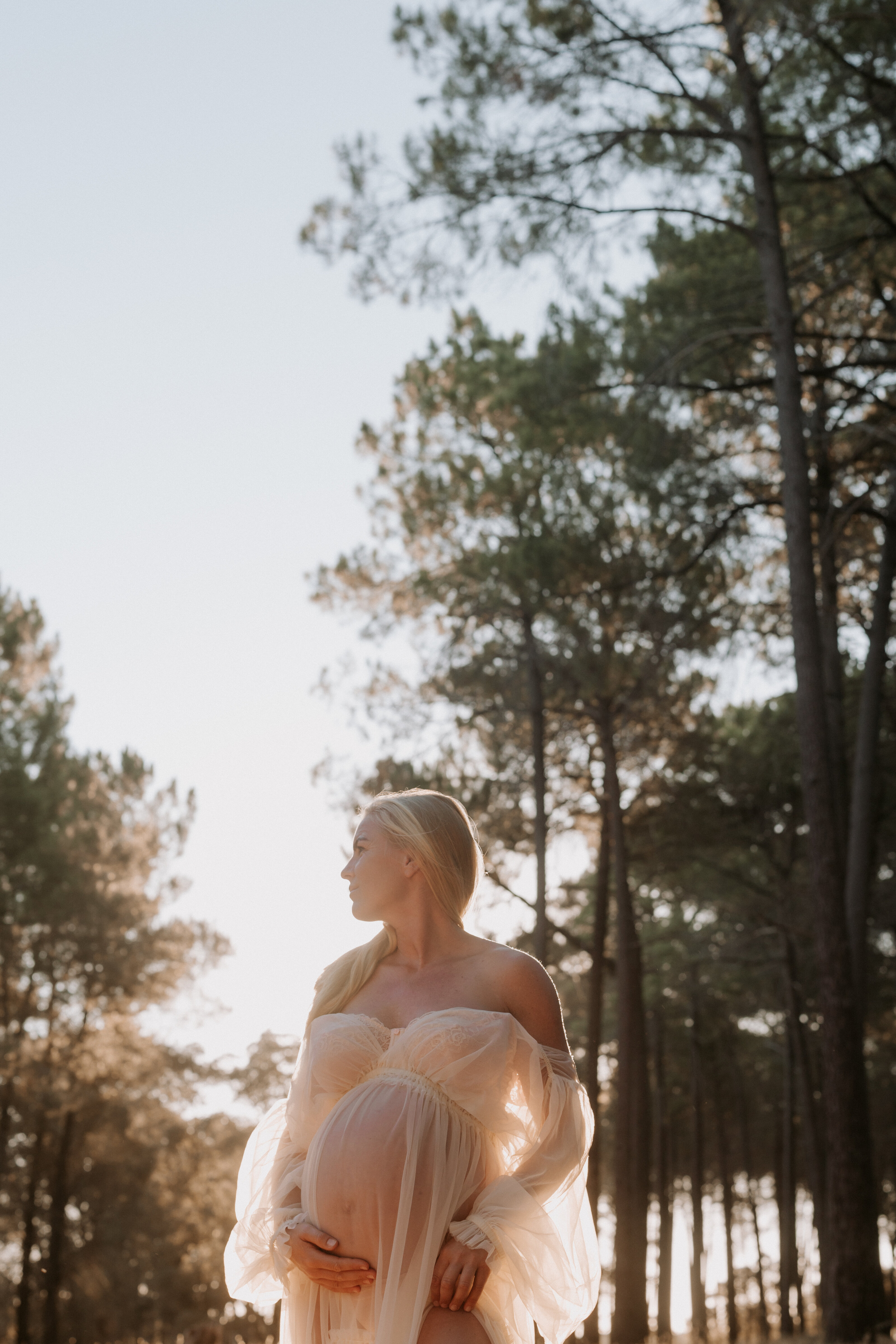 Sun-kissed maternity portrait in a serene outdoor setting in Perth