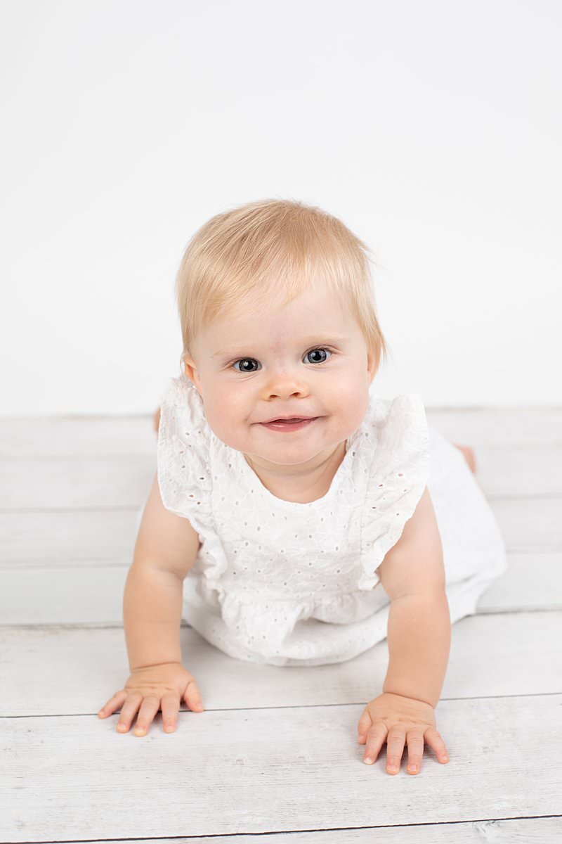 Baby girl crawling for studio portrait session in Maryland