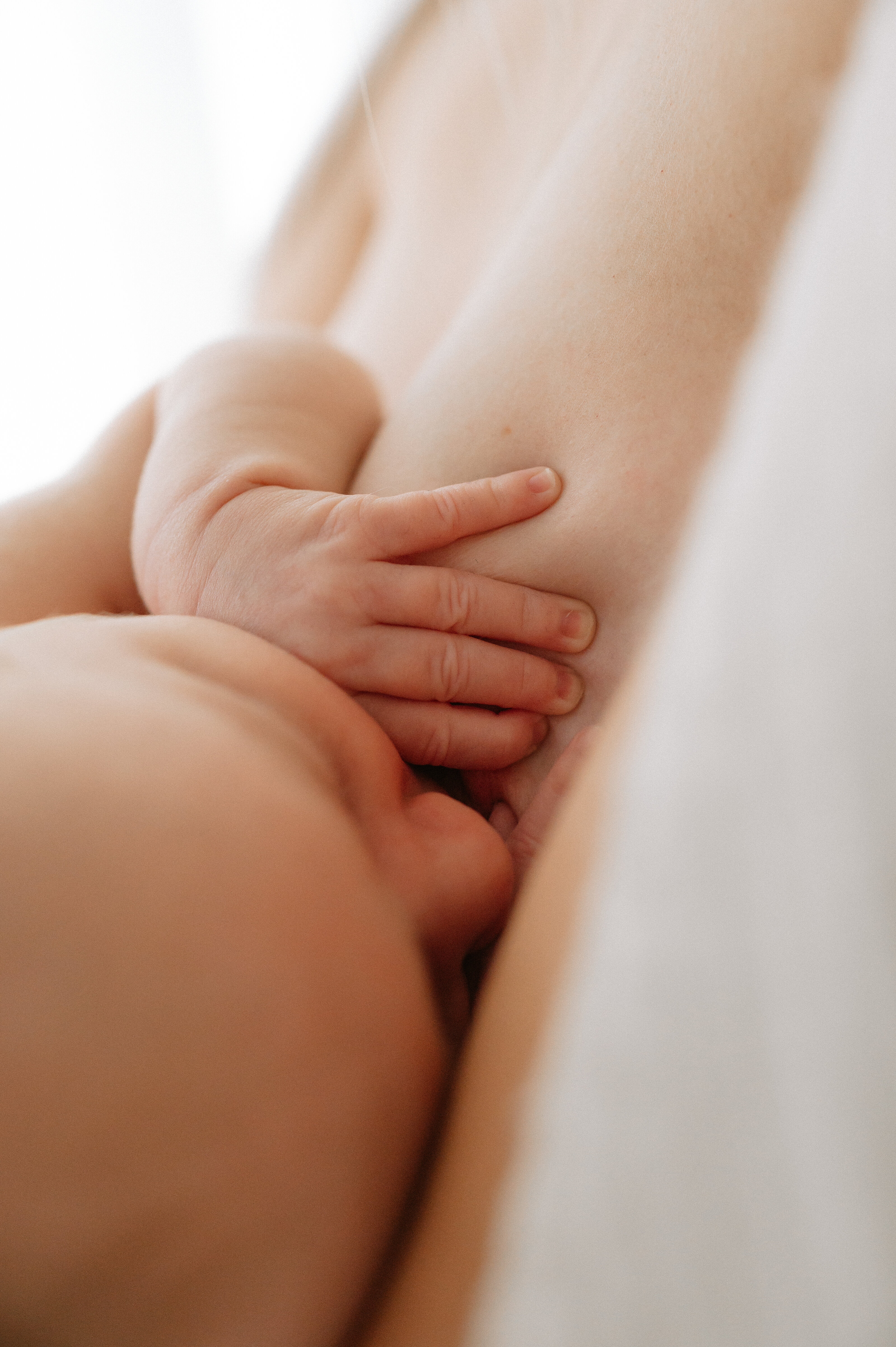 newborn baby girl breastfeeding