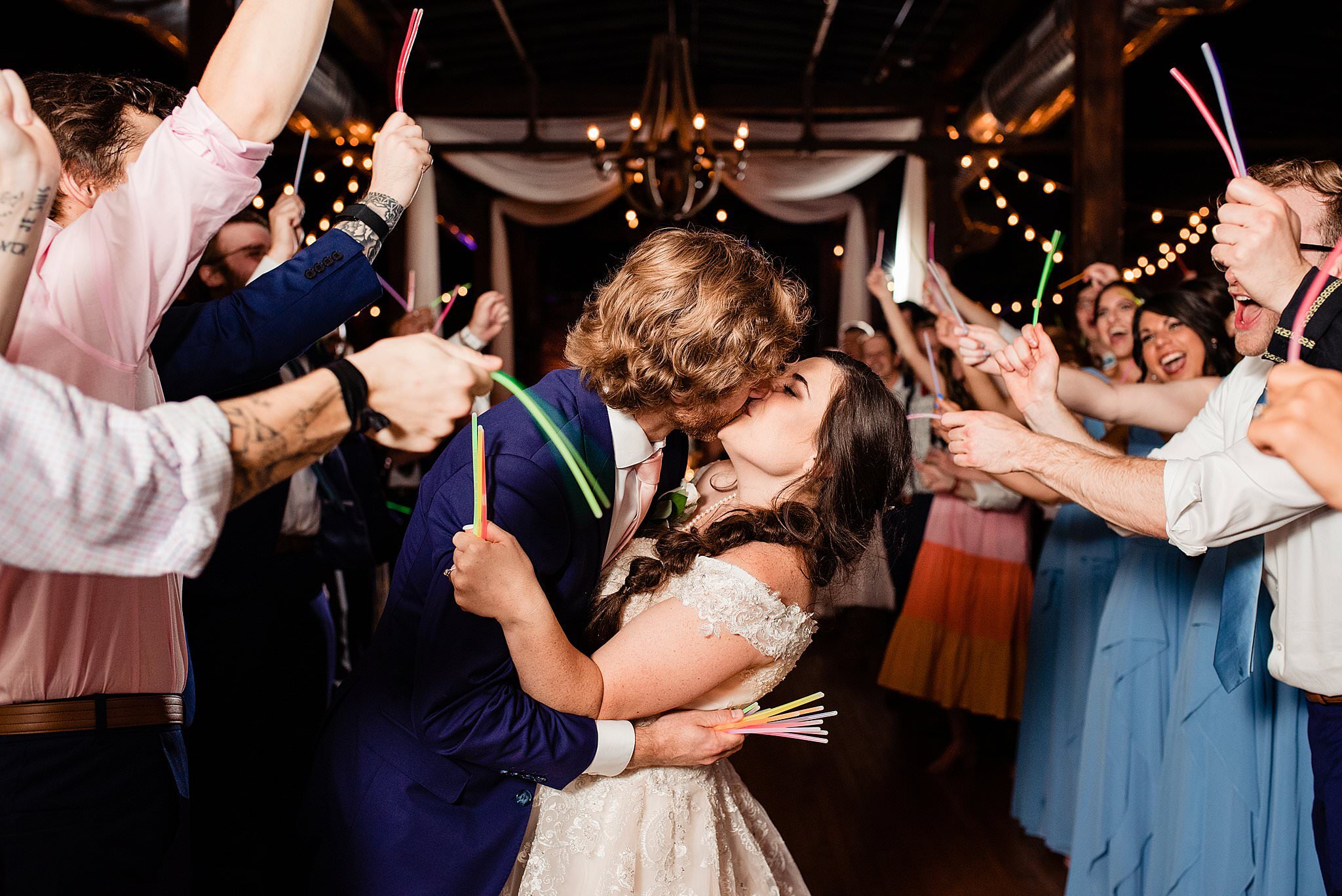 Bride and Groom kissing during reception exit  with glow sticks at Cannery ONE Ballroom