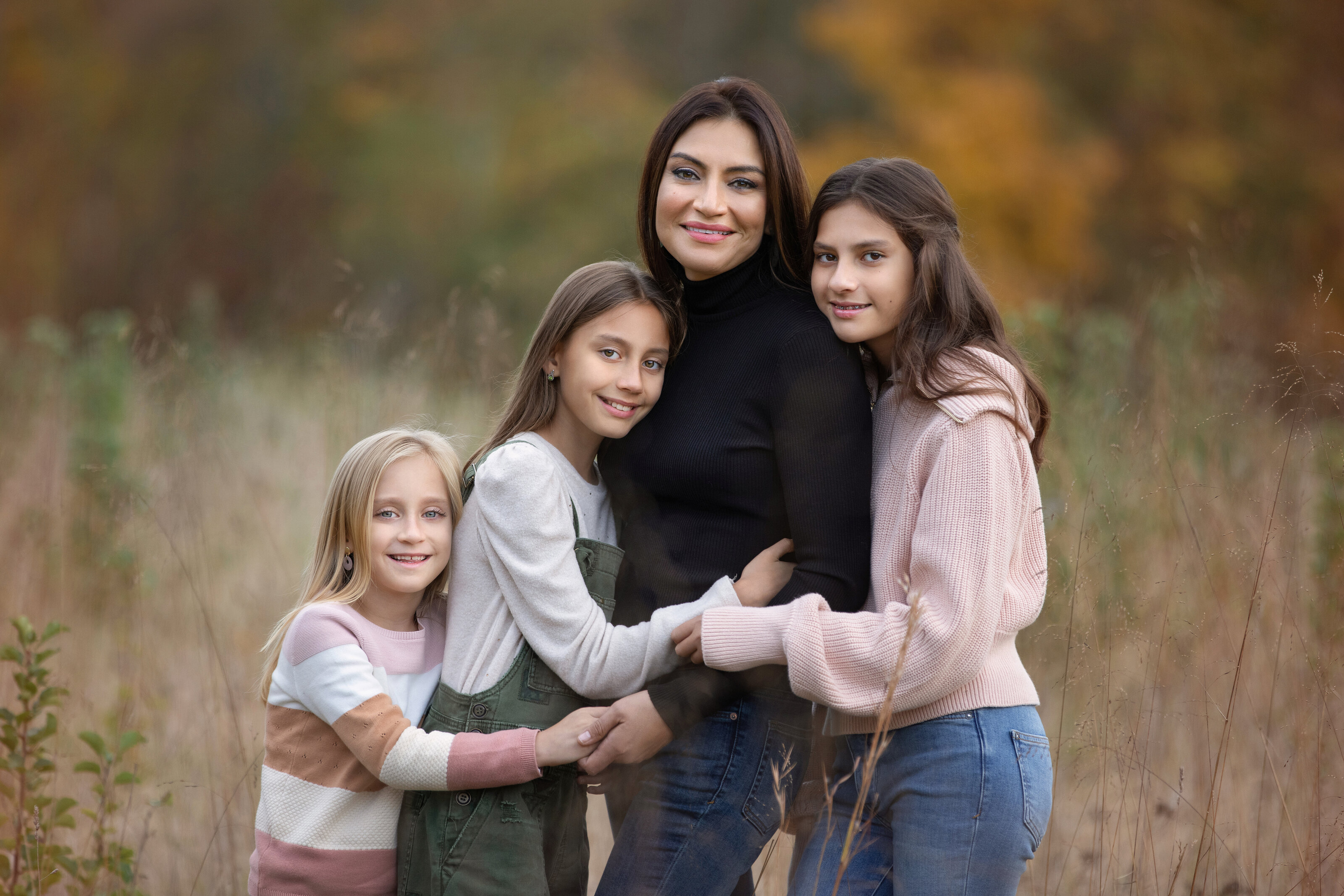 Mom with her daughters hugging for family photography photo shoot  in Princeton, New Jersey.