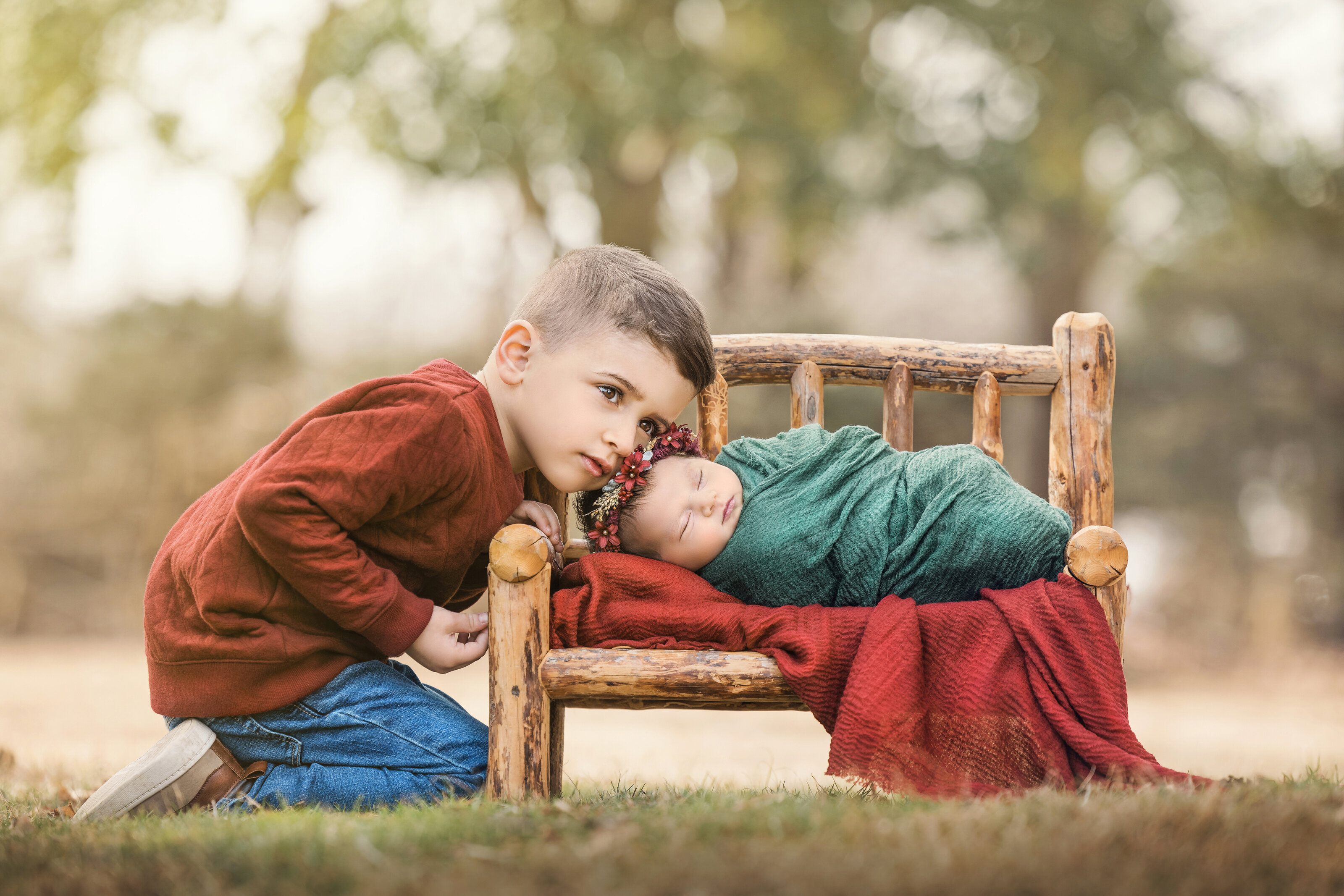 siblings snuggle for the best newborn photographer during shoot  outside in New Jersey