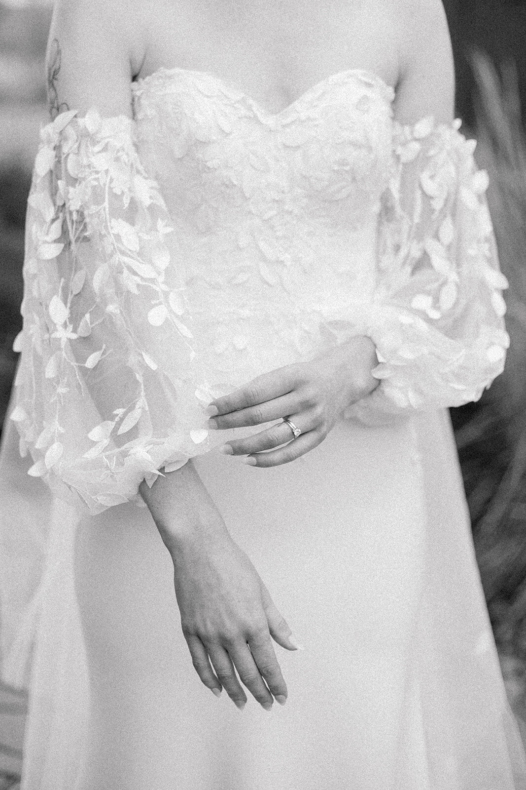 detail of a bride in a lace gown with lace sleeves