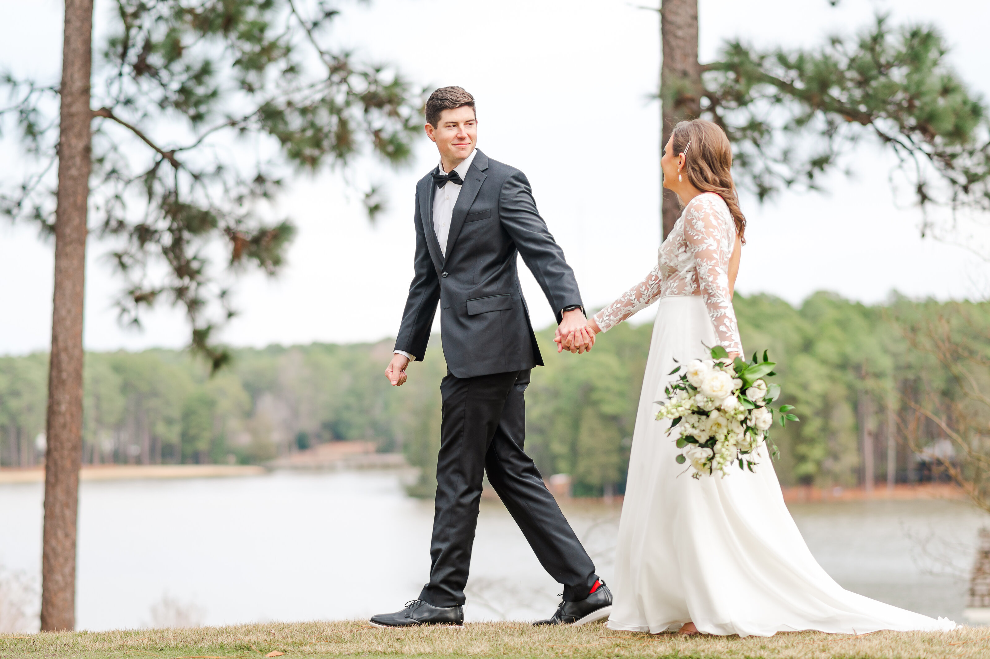 Bride and Groom walking in love around Country Club of North Carolina