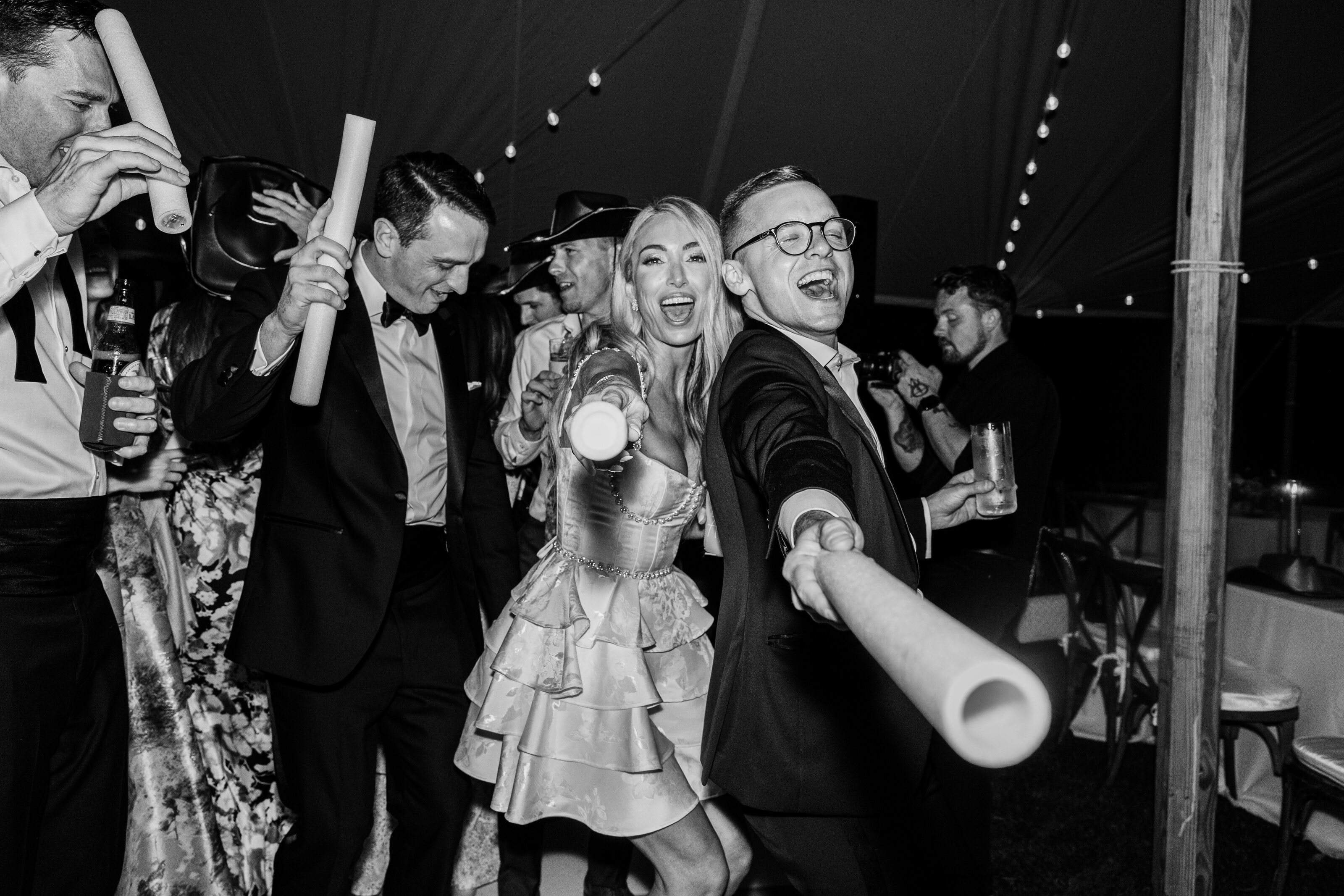 Guests celebrating with joy and energy during a luxury wedding reception at Spring Island, SC. A black-and-white editorial-style capture of an unforgettable night.
