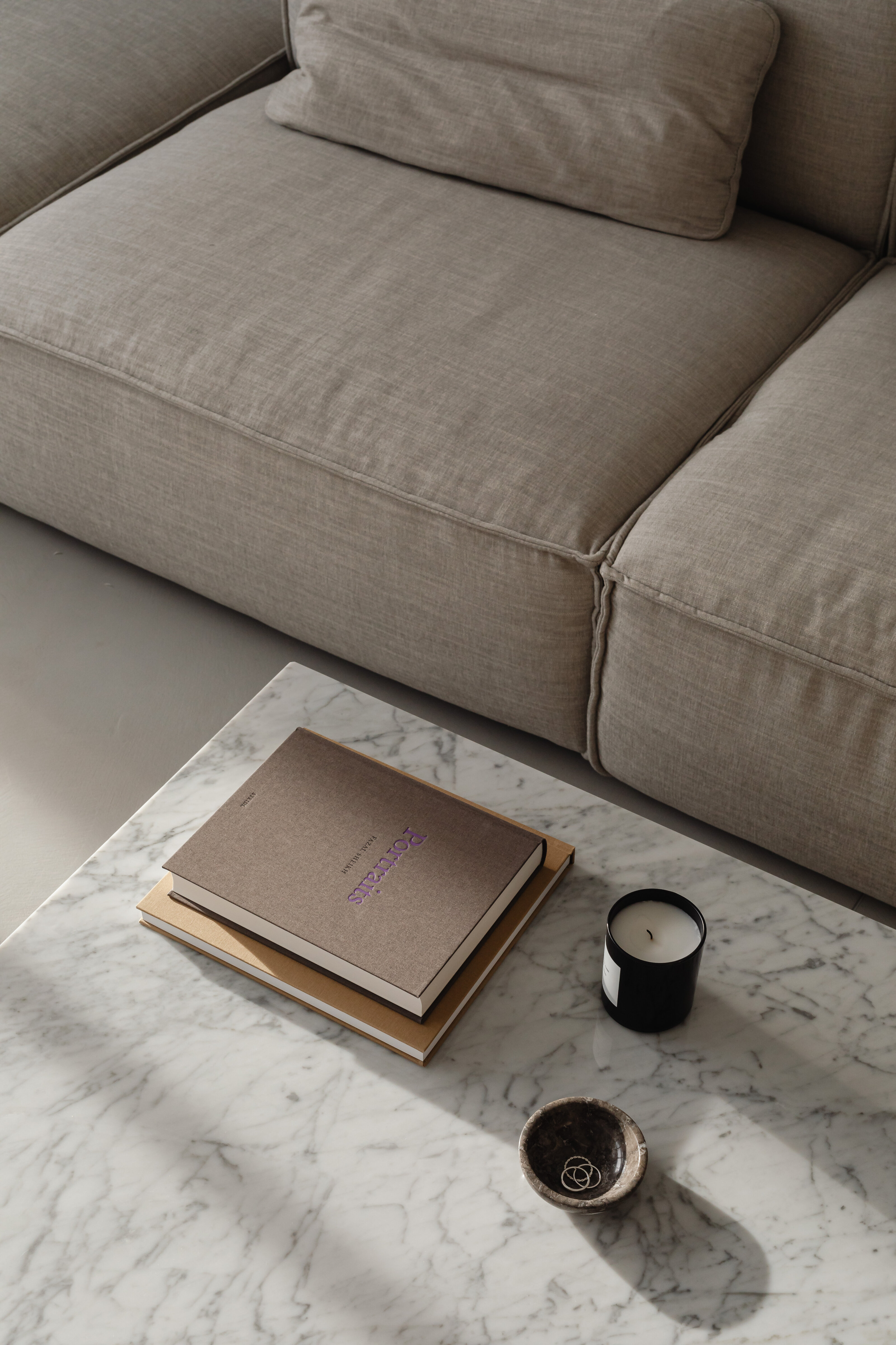 kaboompics_living-room-gray-beige-sofa-marble-coffee-table-coffee-table-books-candle-29384