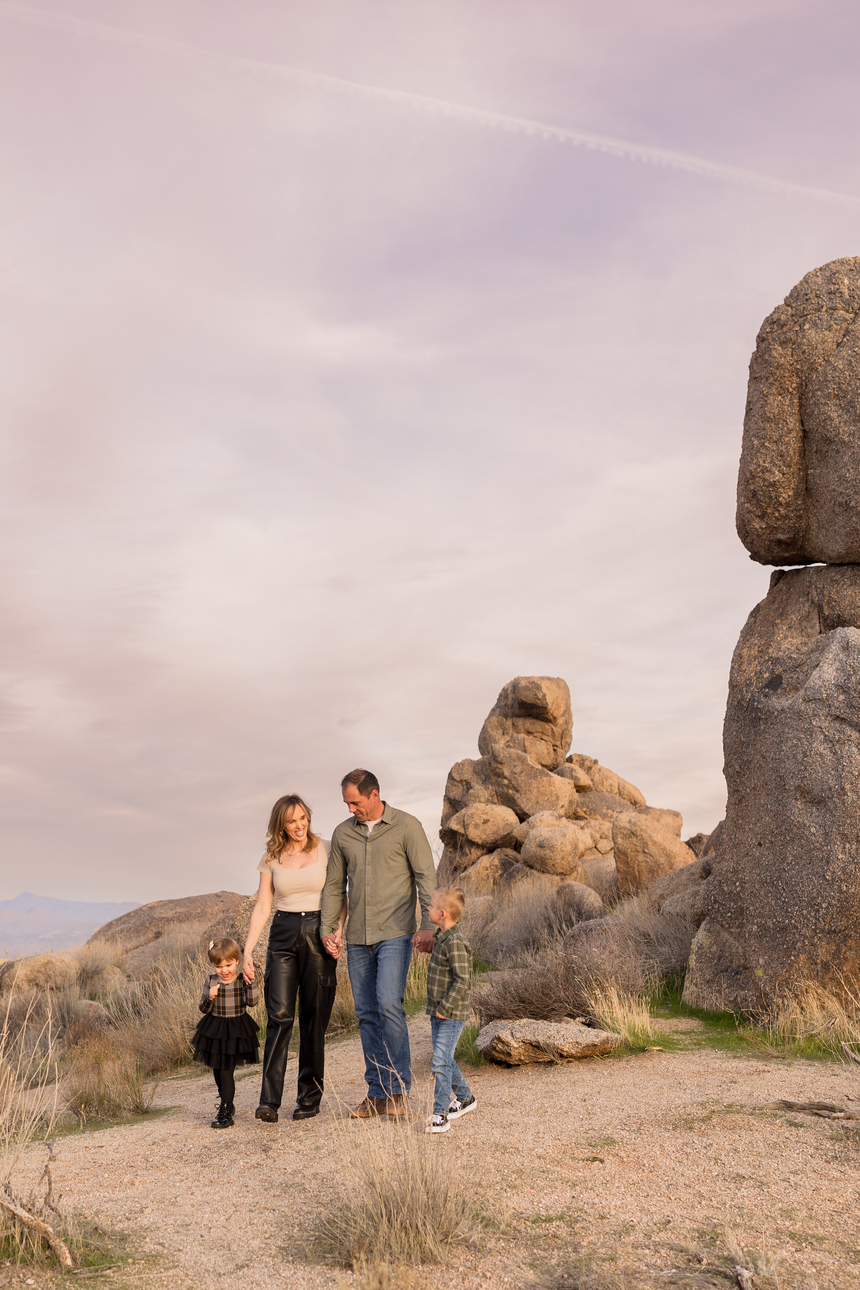 family photo of four people infront of scottsdale arizona boulders