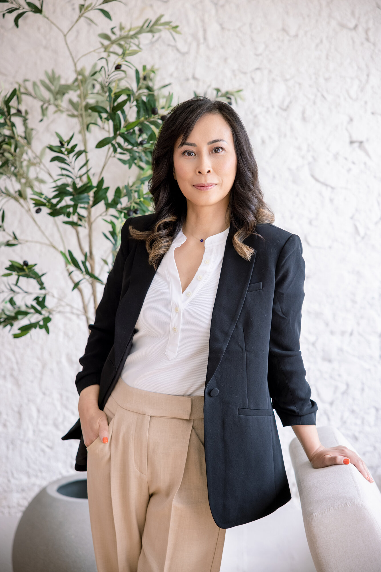 A woman in a jacket looks at the camera