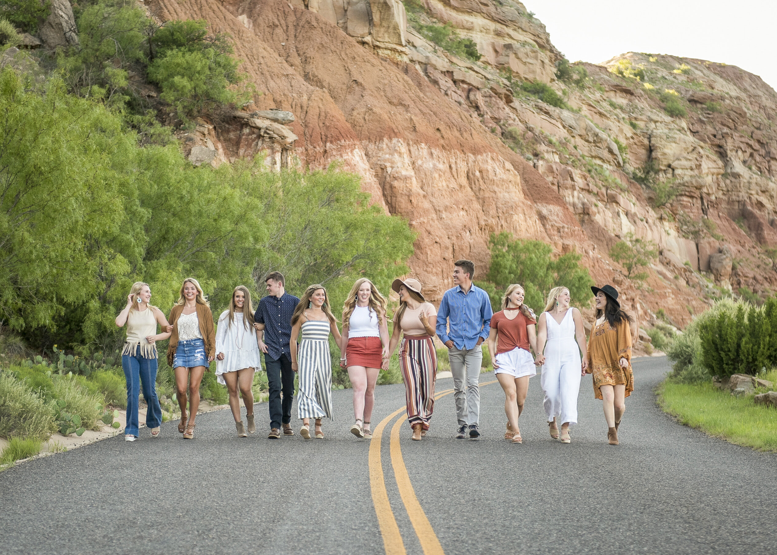 group of high school seniors walk in palo duro canyon