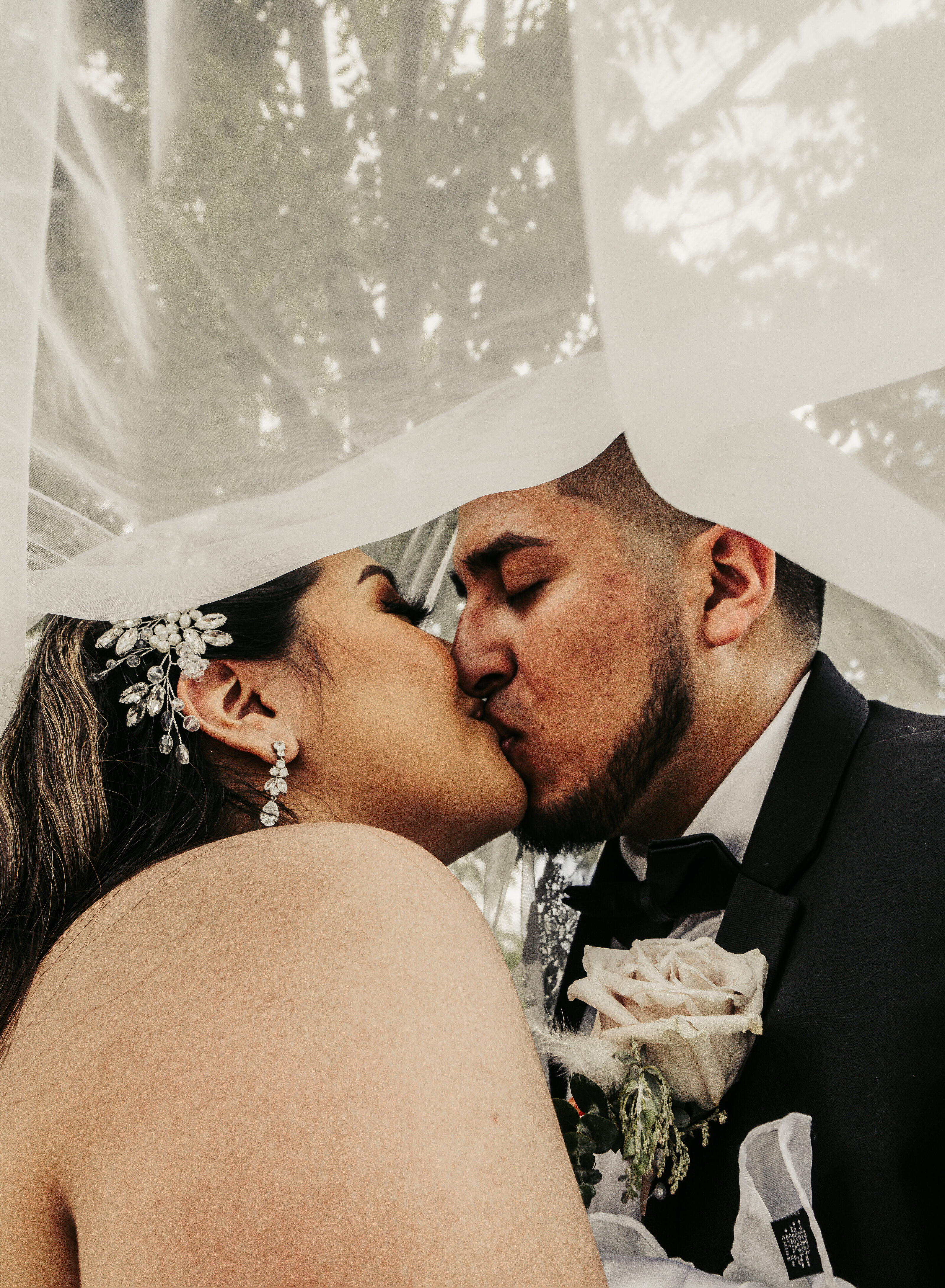 kissing bride and groom myriad botanical wedding
