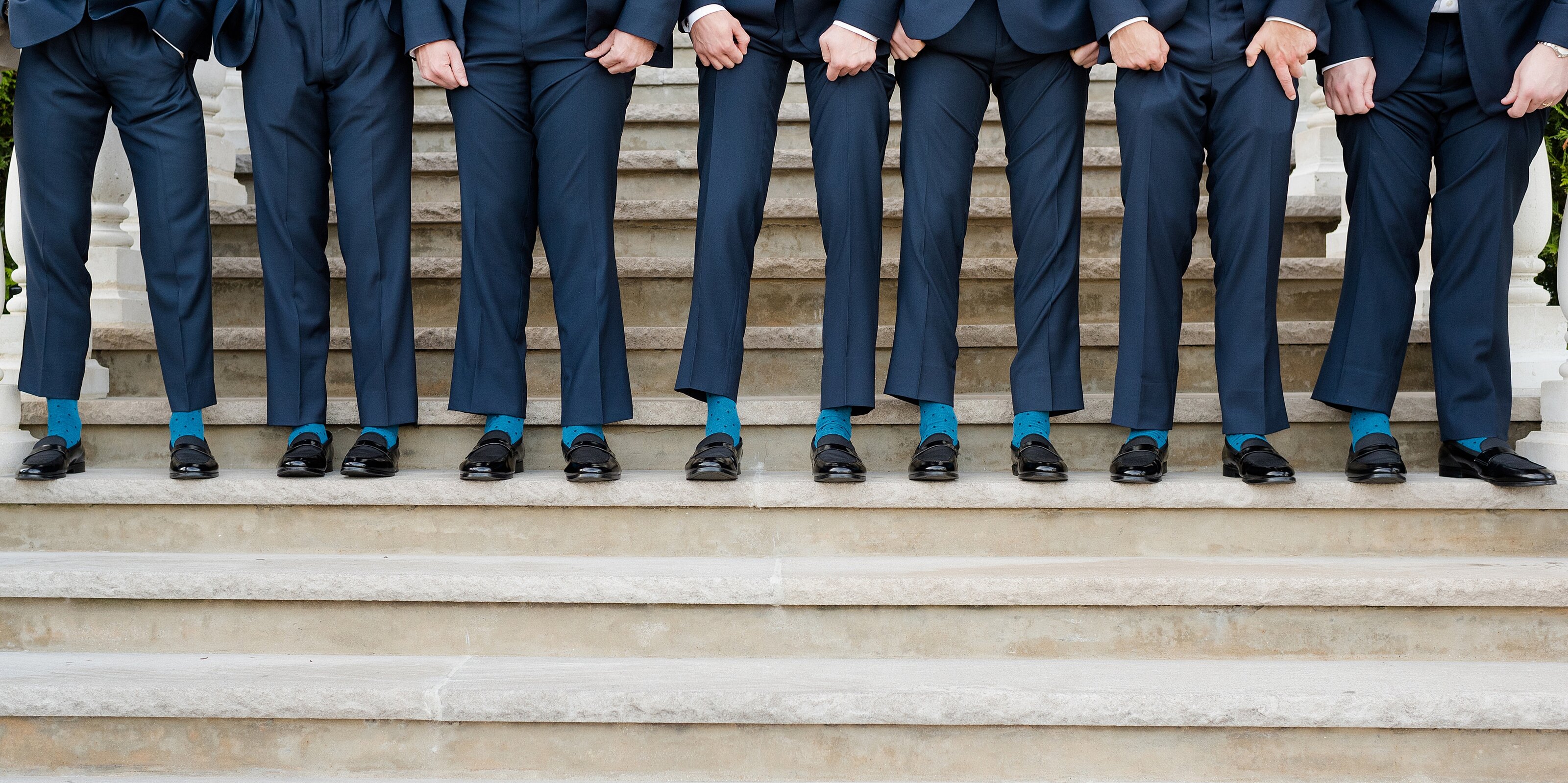 10_groomsmen-line-up-on-step-to-show-matching-socks
