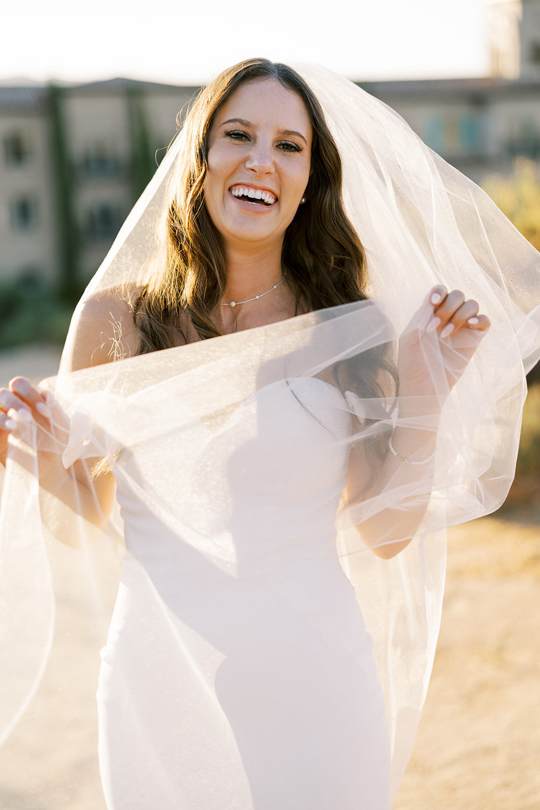 bride laughing on her wedding day during sunset