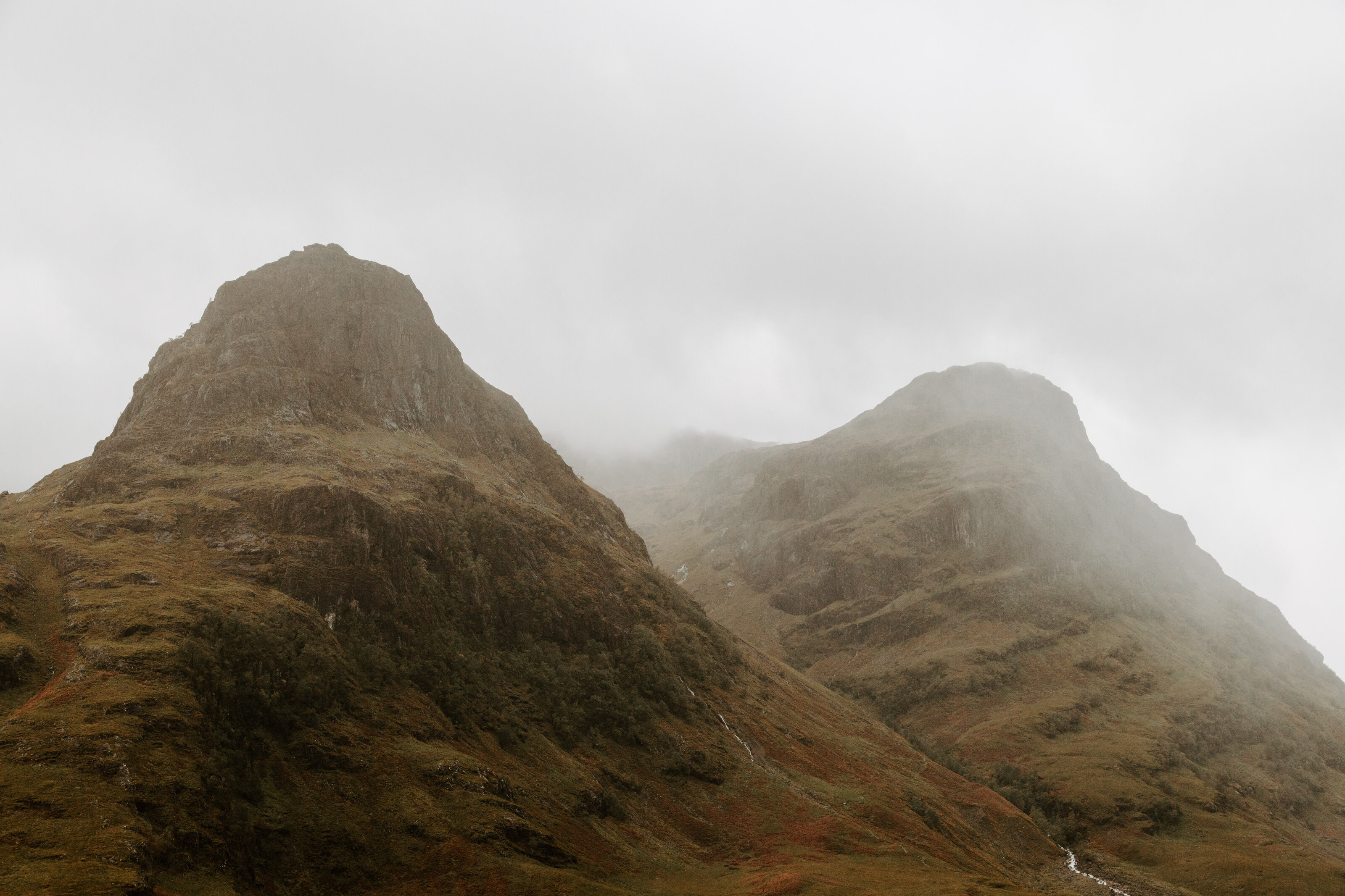 scotland bride overlooking valley at sunrise after elopement