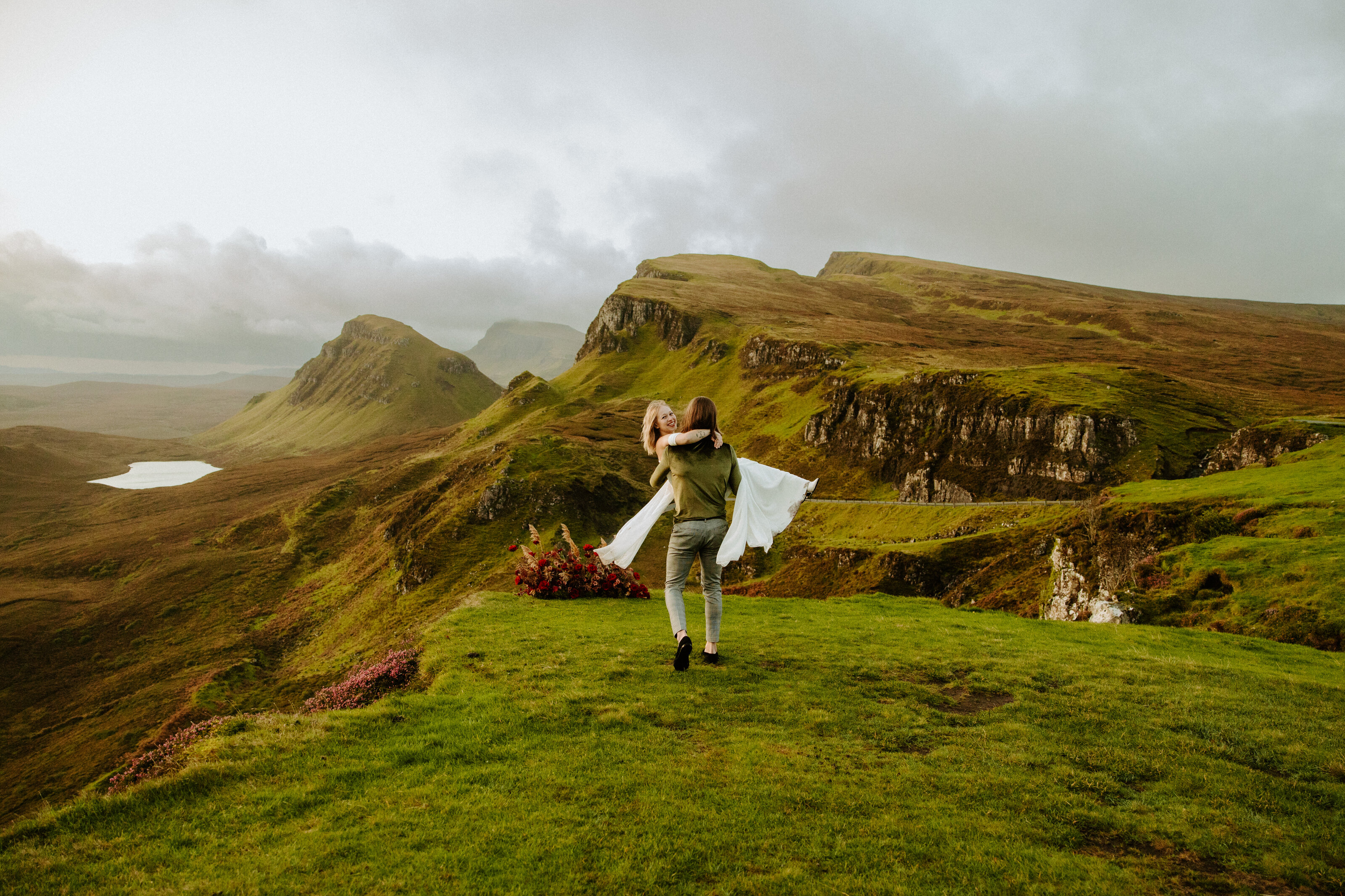 bride and groom on the cliffs of scotland at sunrise