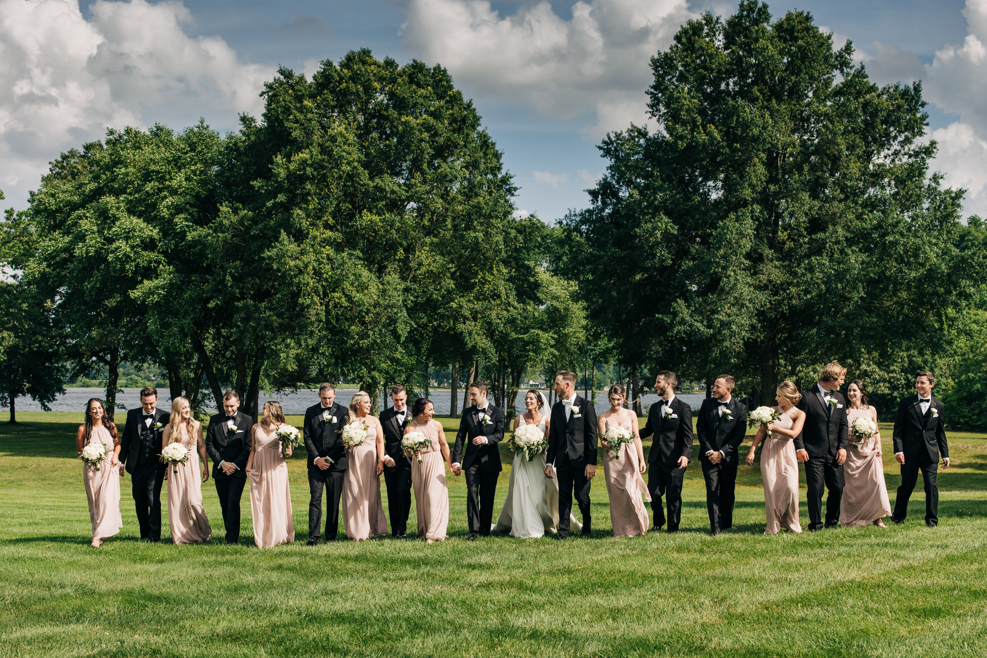 Wedding party walks for photos taken by best wedding photographer in New jersey