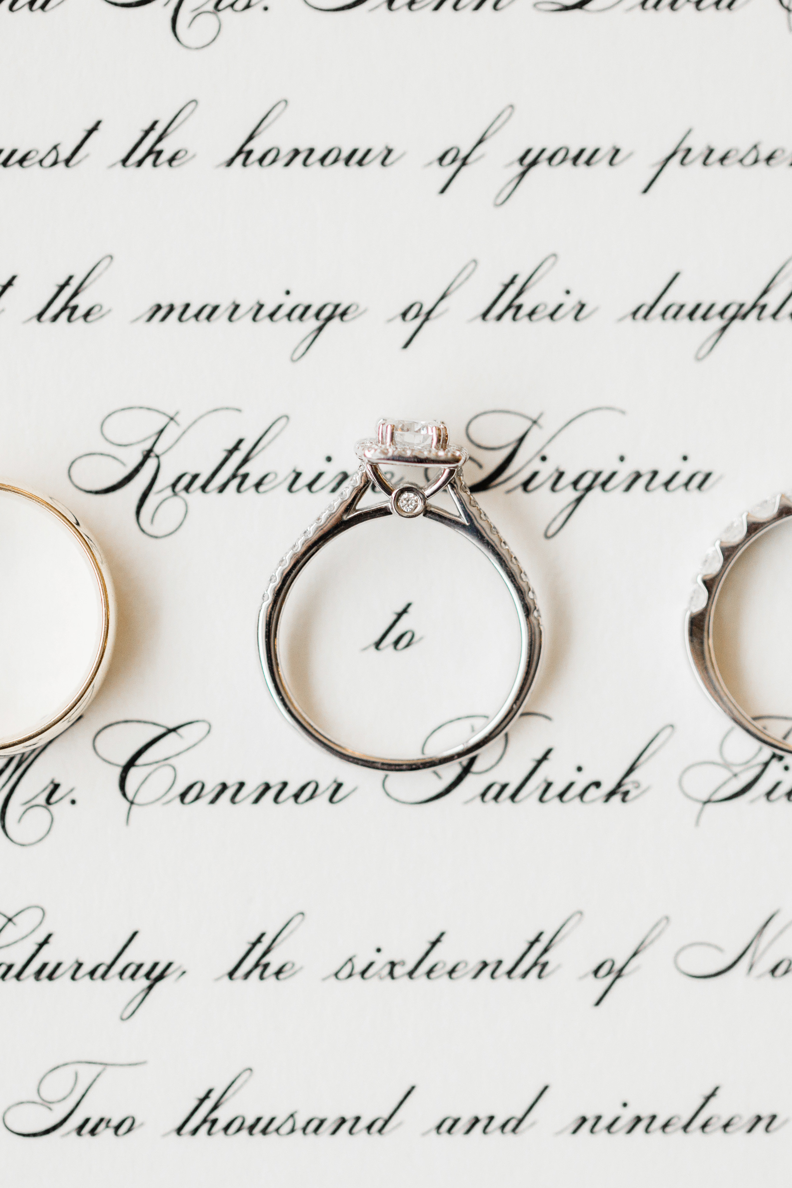 Invitations make the best backdrop for a close up of wedding rings