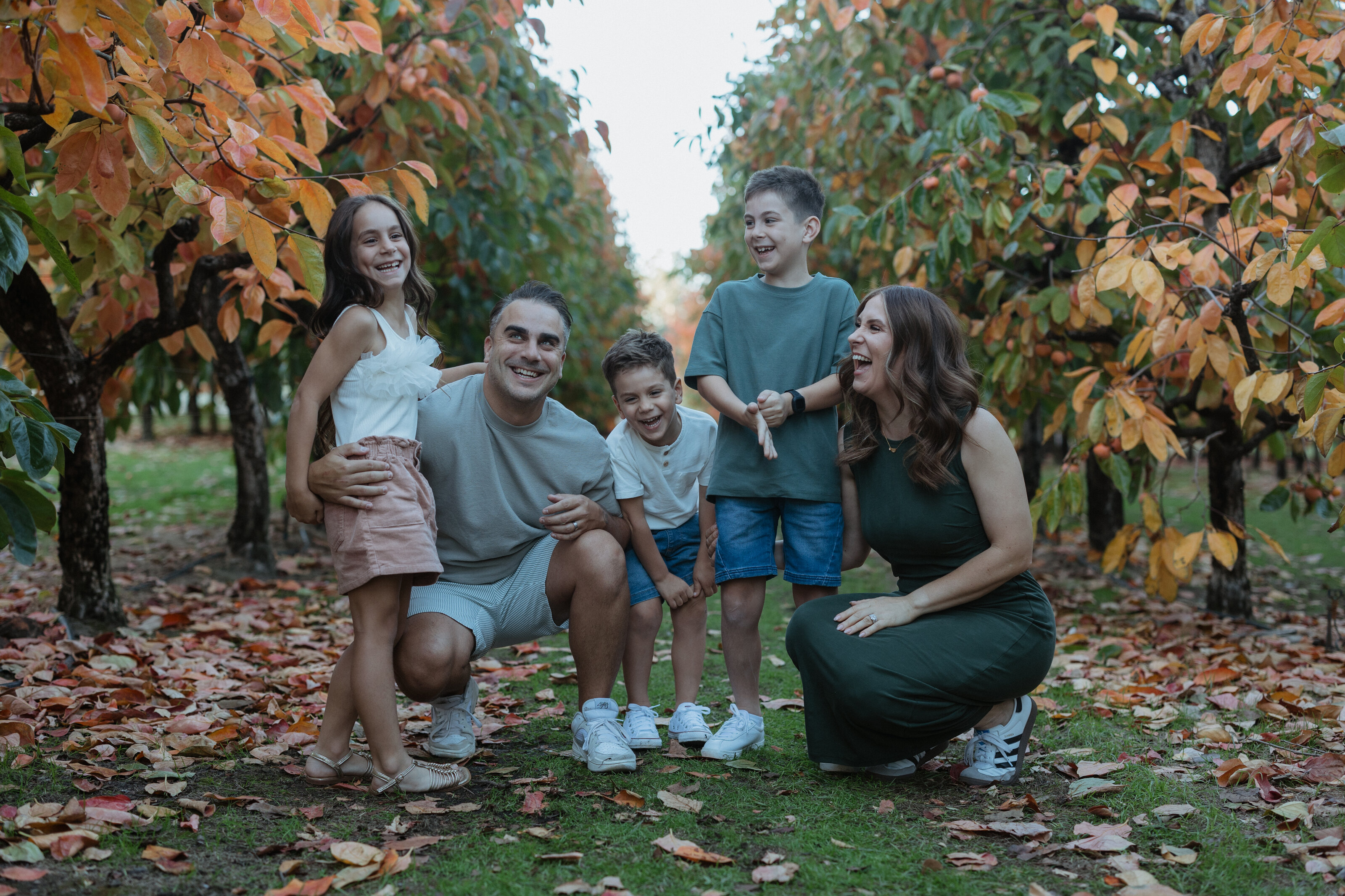 Joyful family laughing together during an outdoor session in Perth