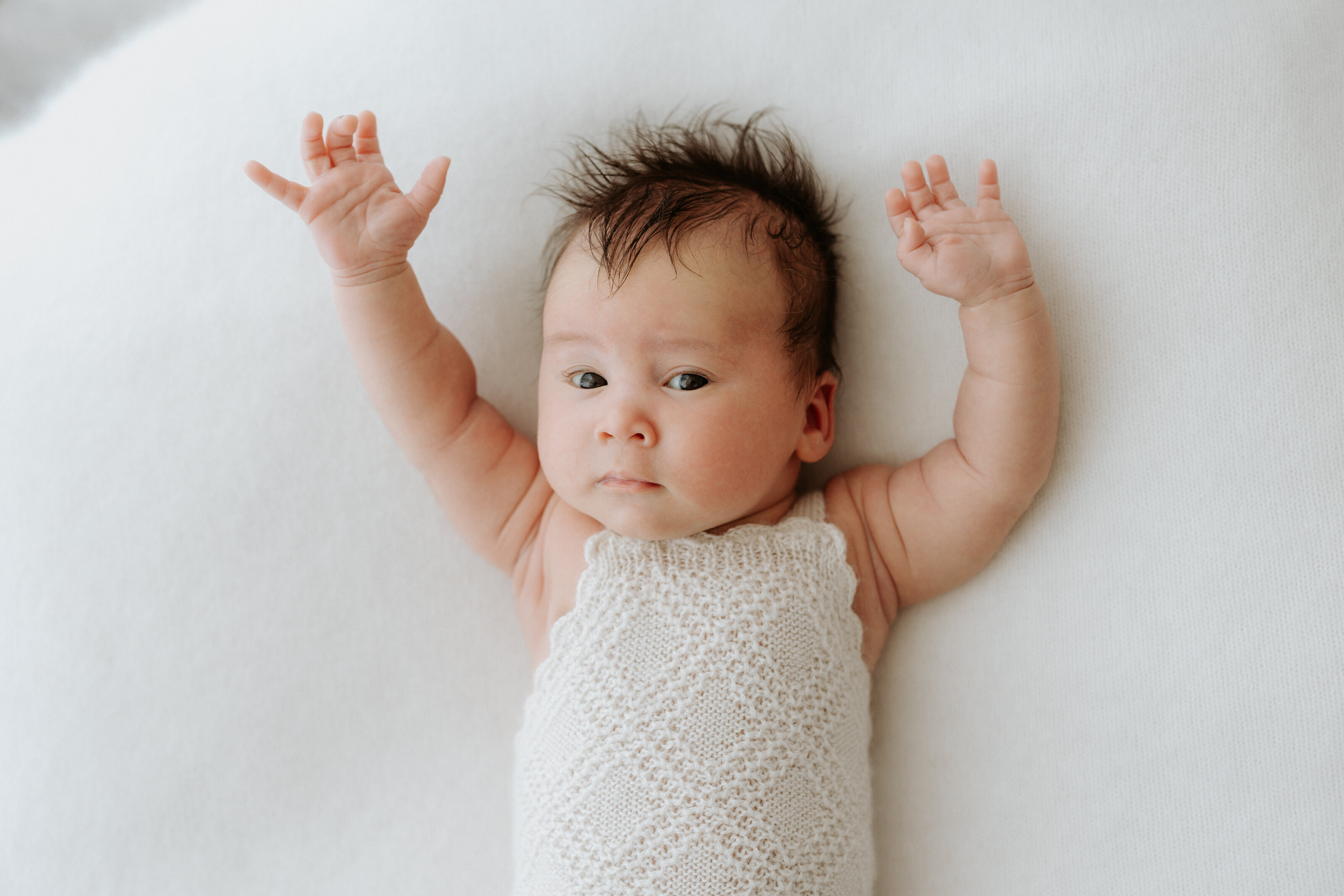 Precious newborn expressions captured in a cozy indoor setting in Perth