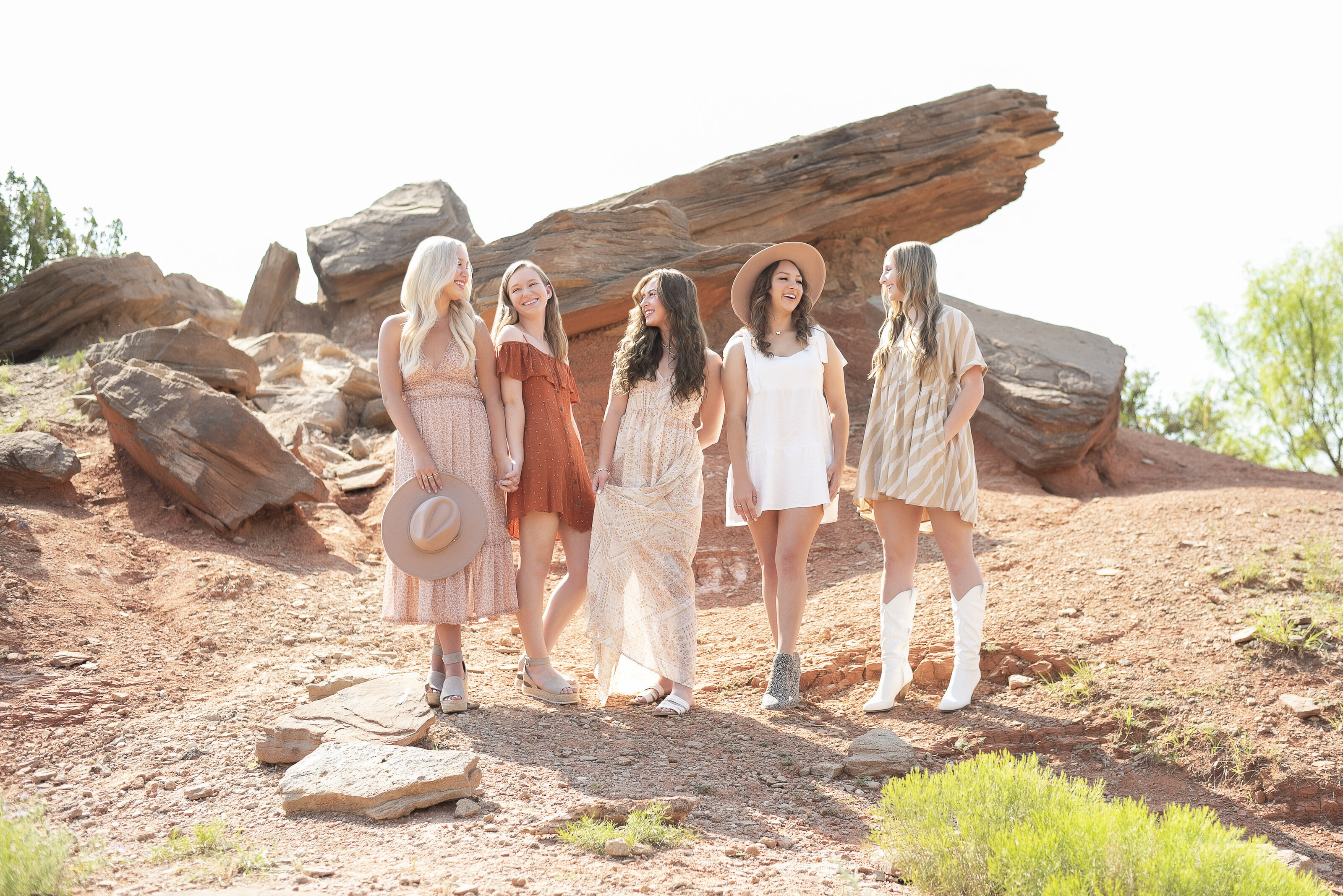 5 high school seniors dressed boho on a lookout pier in palo duro canyon