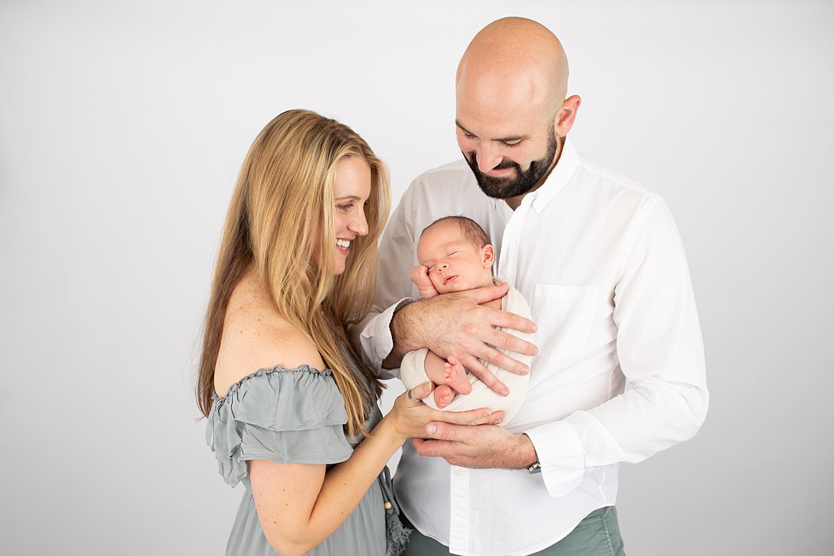Dad holding baby in studio for Columbia MD newborn photography session