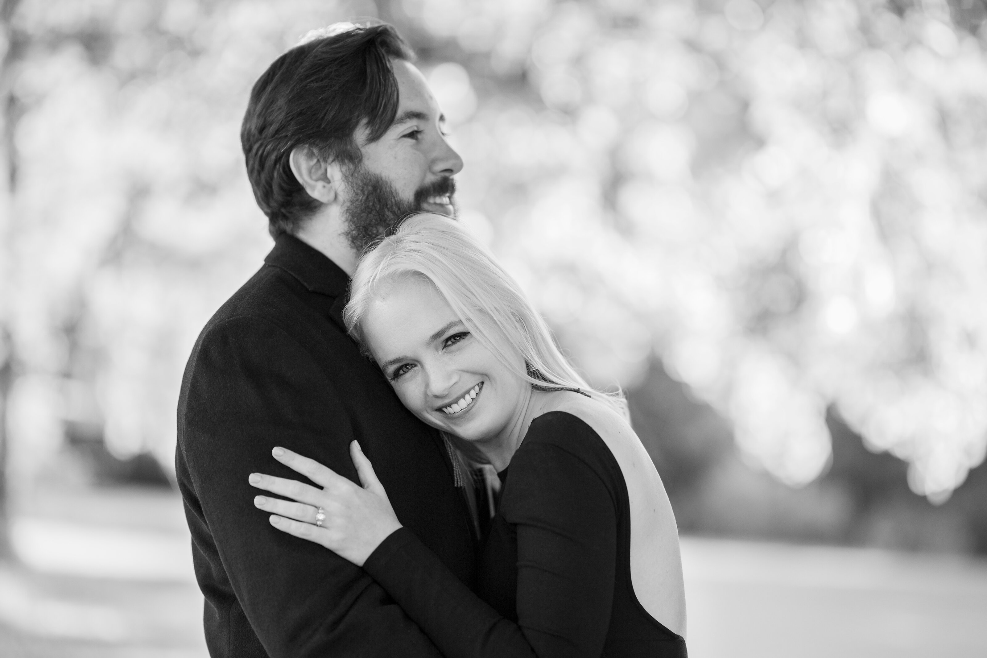 Engaged couple laugh during photoshoot before wedding day