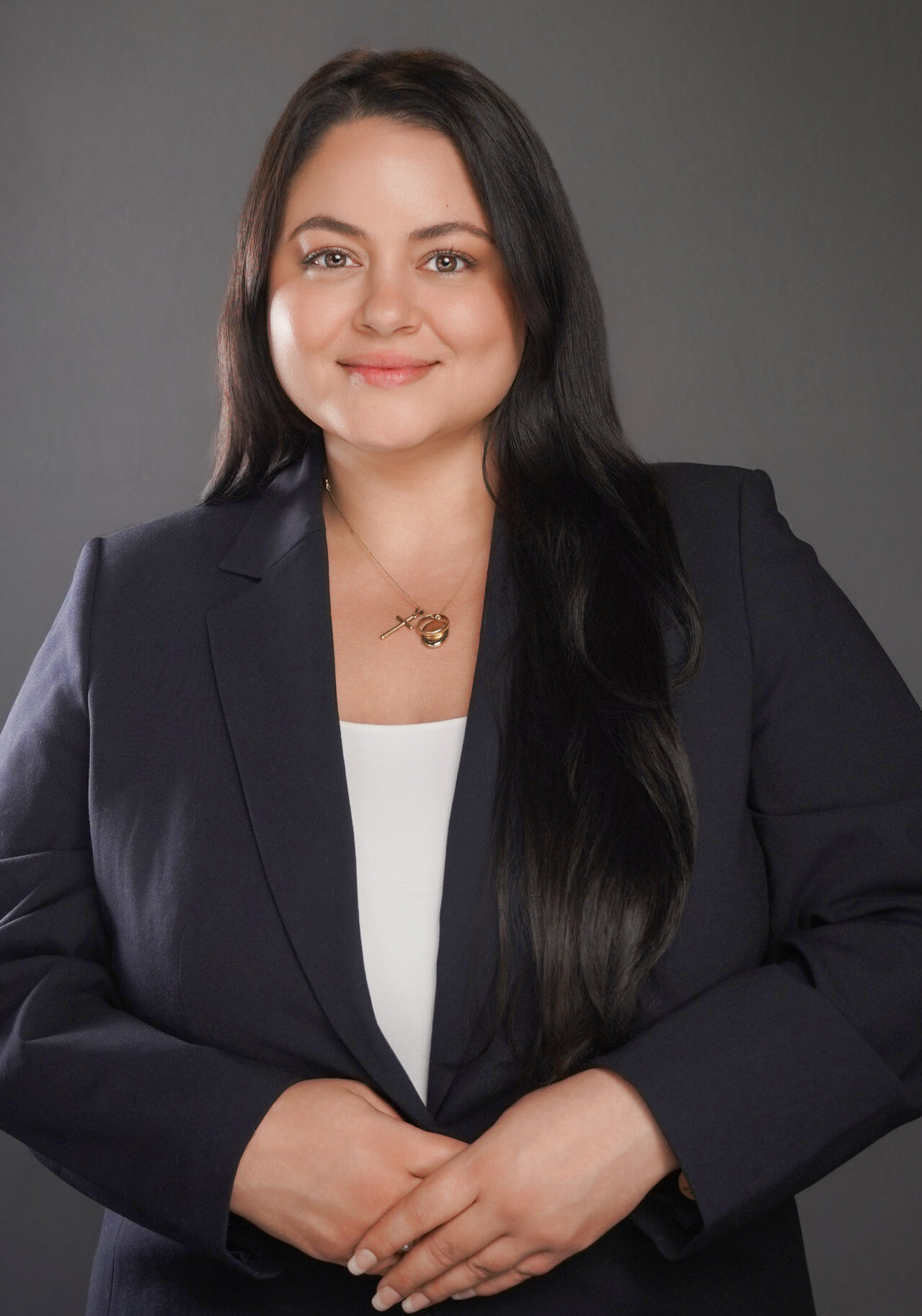 Professional headshot of a woman with long black hair in a navy blazer, captured by Lynda Louis Photography in Atlanta for corporate branding