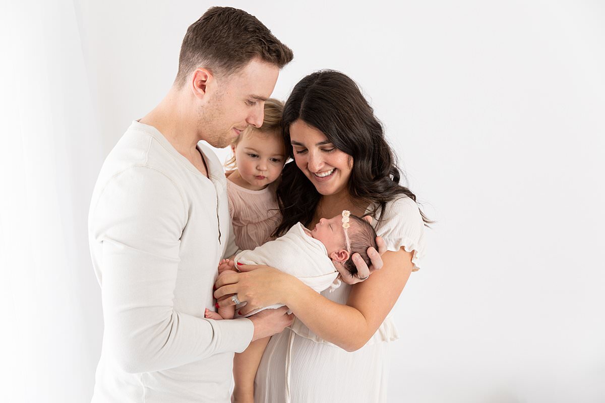 Family of 4 with new baby in studio for newborn photography columbia md session