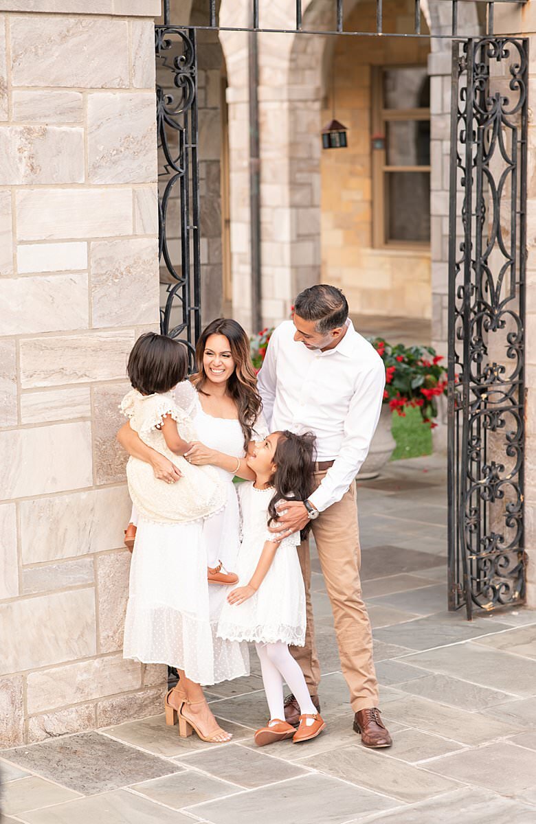 Family of four wearing neutral colors outdoors by Maryland Family Photographer