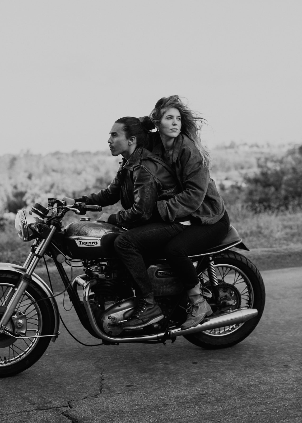 Couple take a ride on a vintage Triumph motorcycle for their editorial style engagement photoshoot