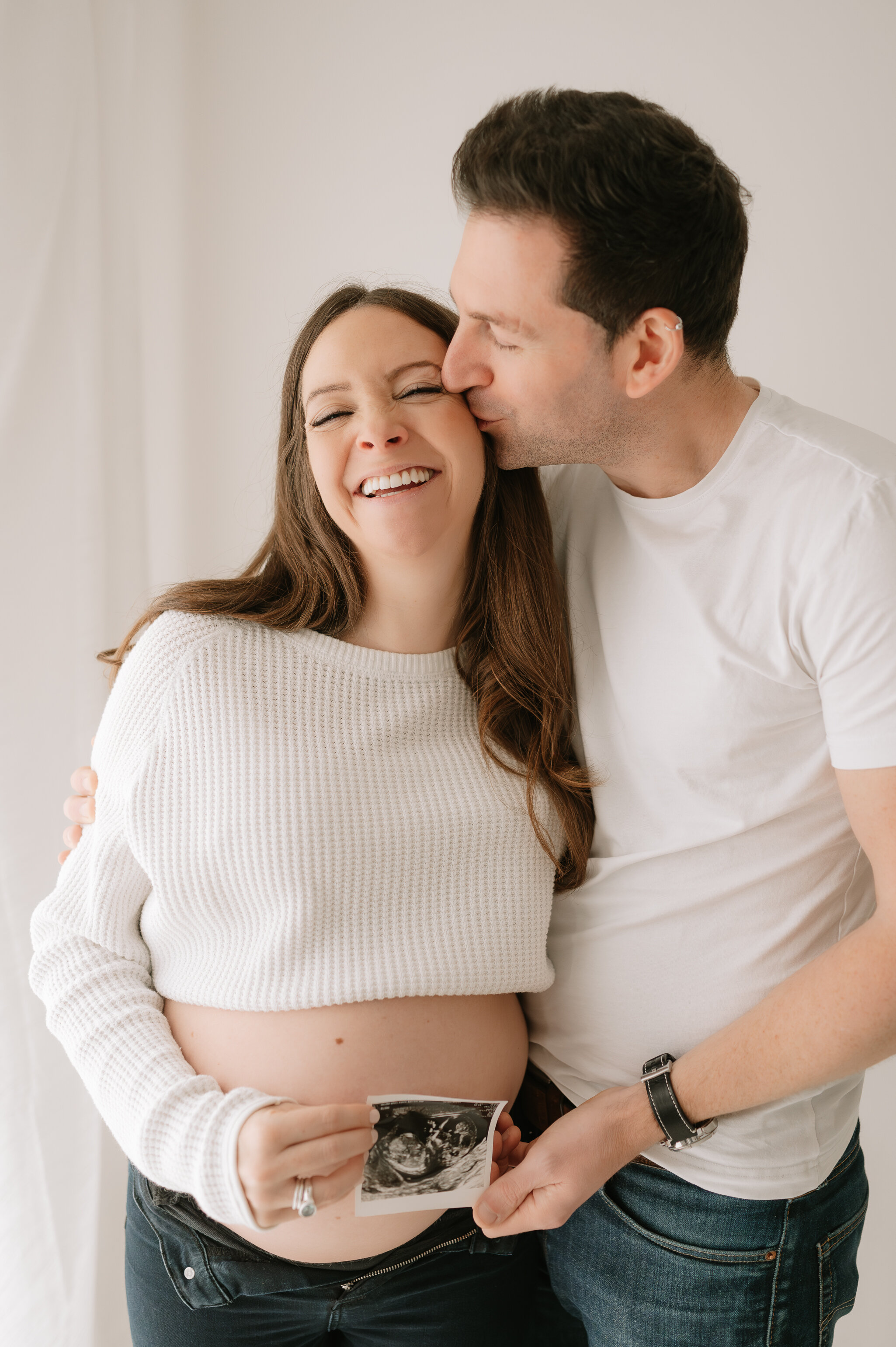 pregnant Mum with Dad holding their pregnancy scan photo