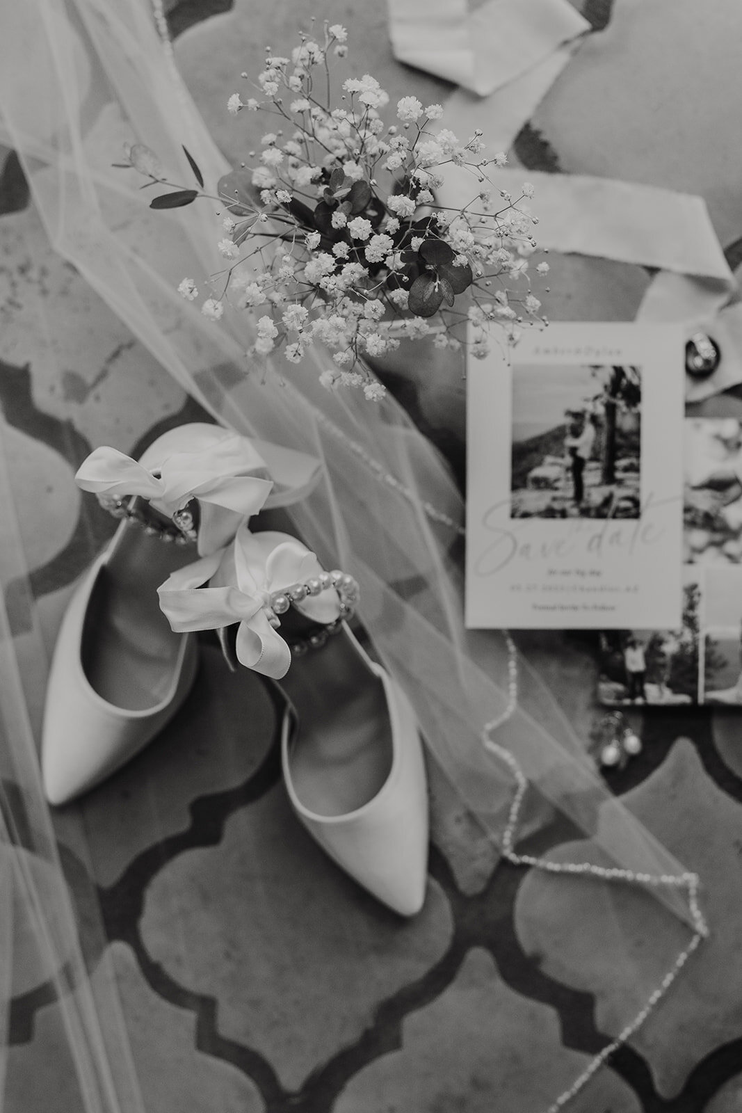 white heels invitations flowers and veil sitting on top of terracotta tile at bella rose estate in chandler arizona