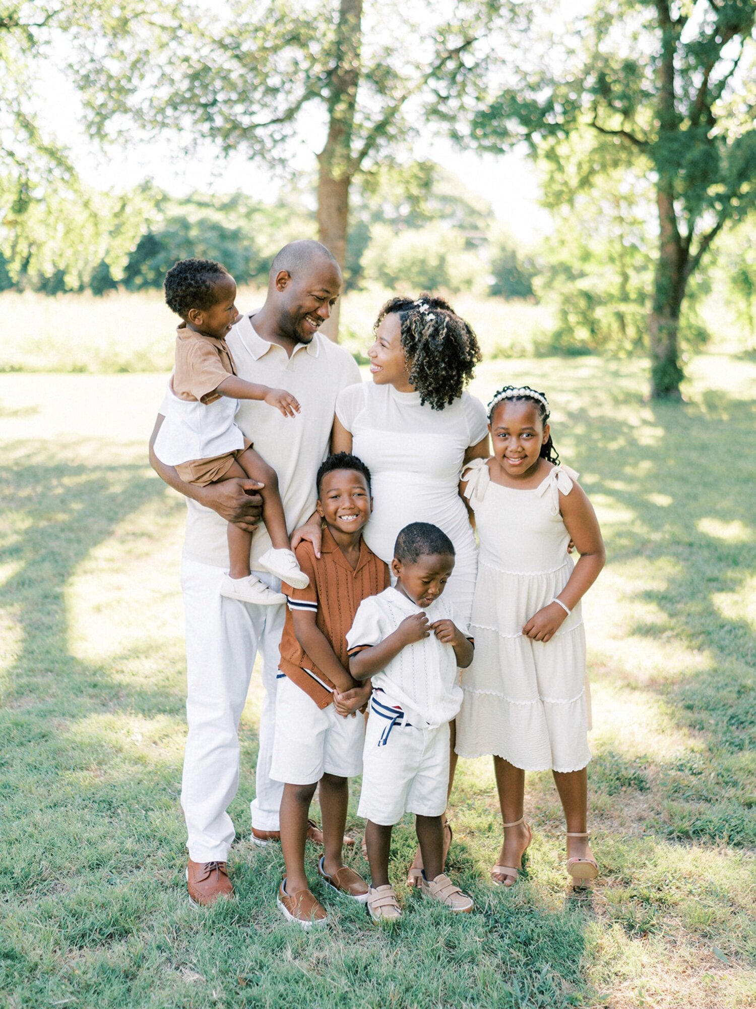 Family in Dallas smiling in yard for photography session